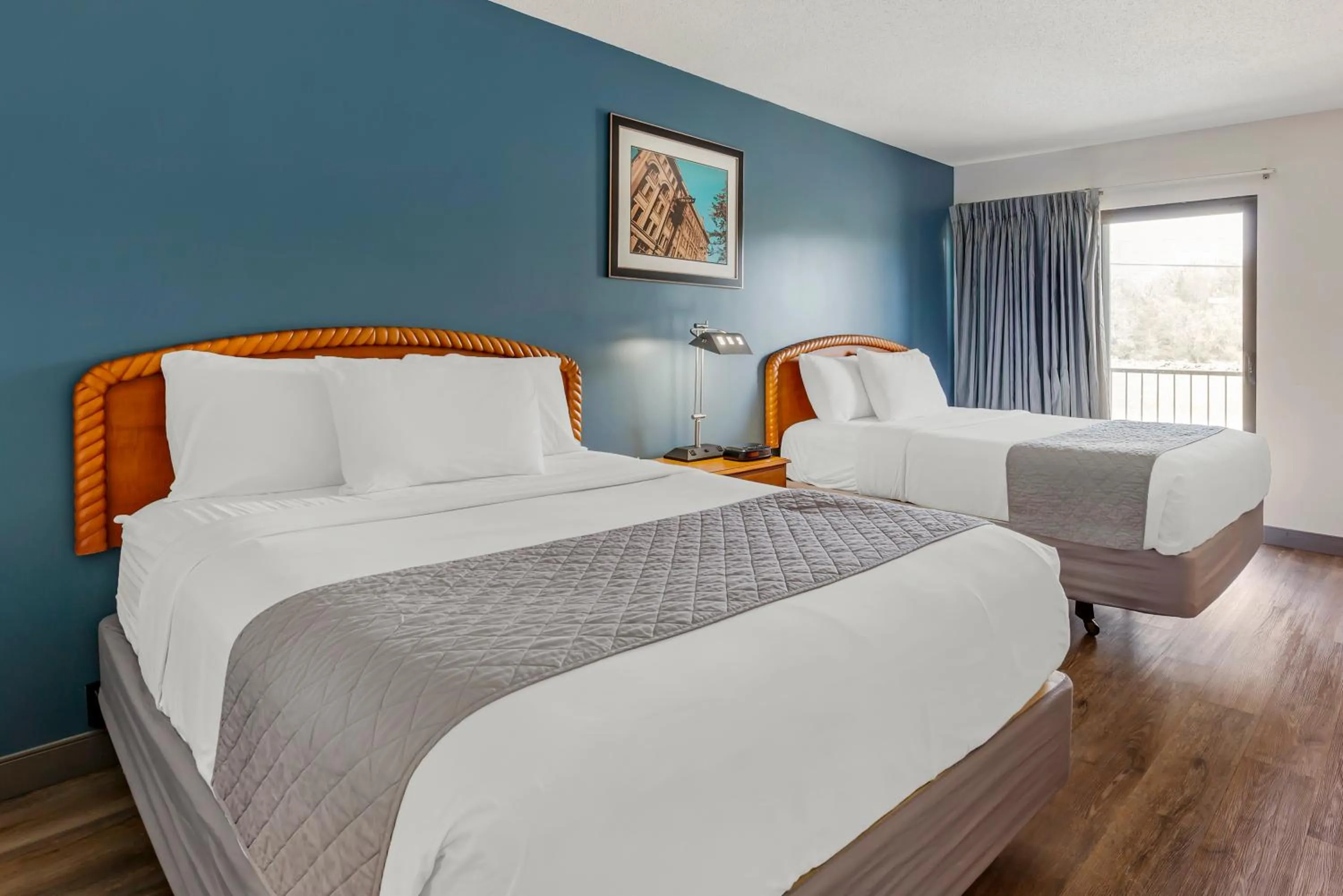 Bed in Polynesian Hotel & Suites