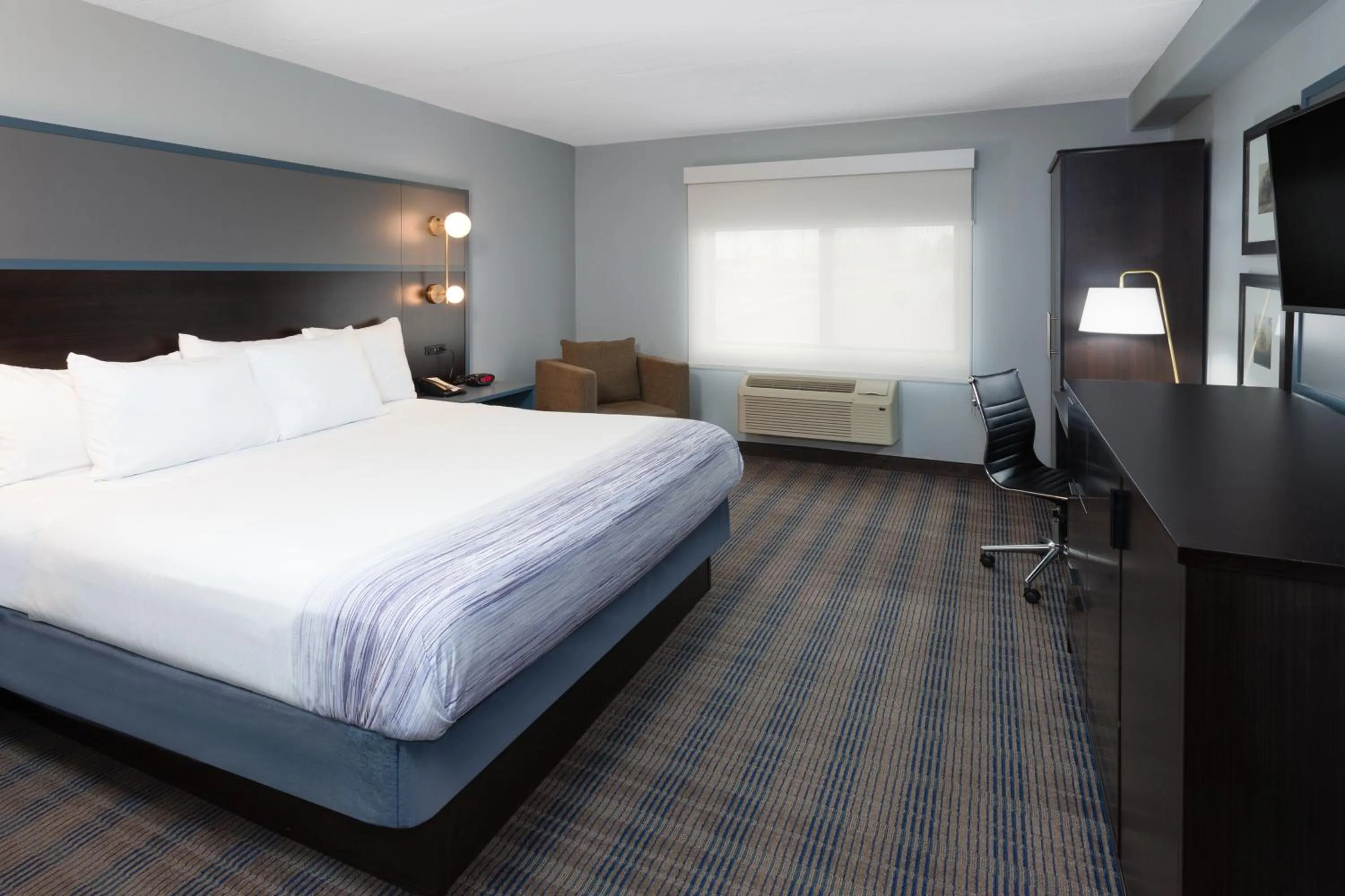 Bed in AmericInn by Wyndham Peoria