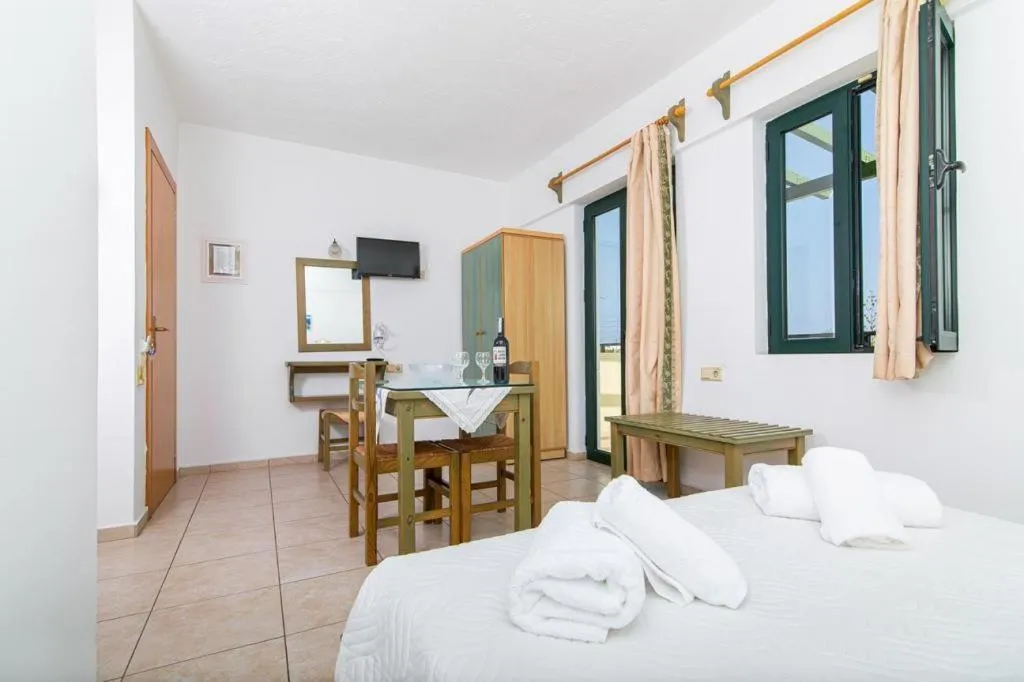 Bed in Dionysos Apartments & Studios