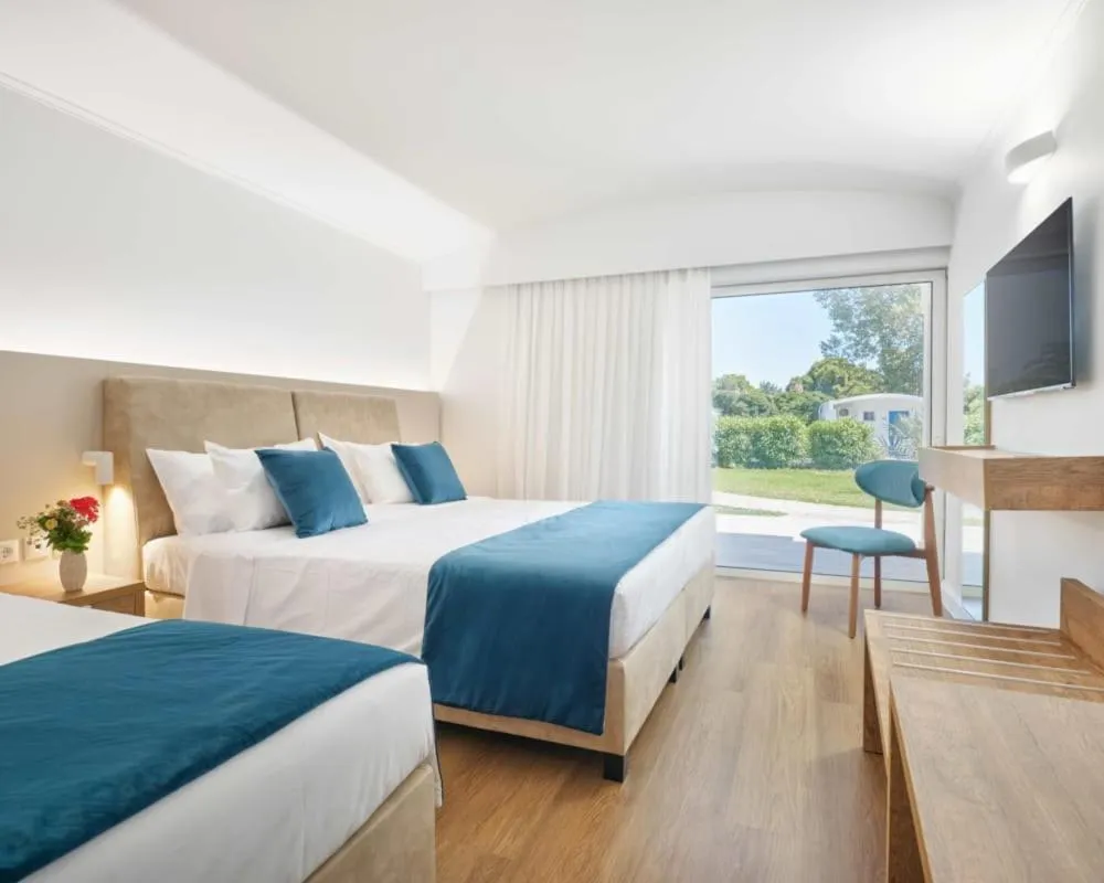 Bed in Kinetta Beach Resort and Spa