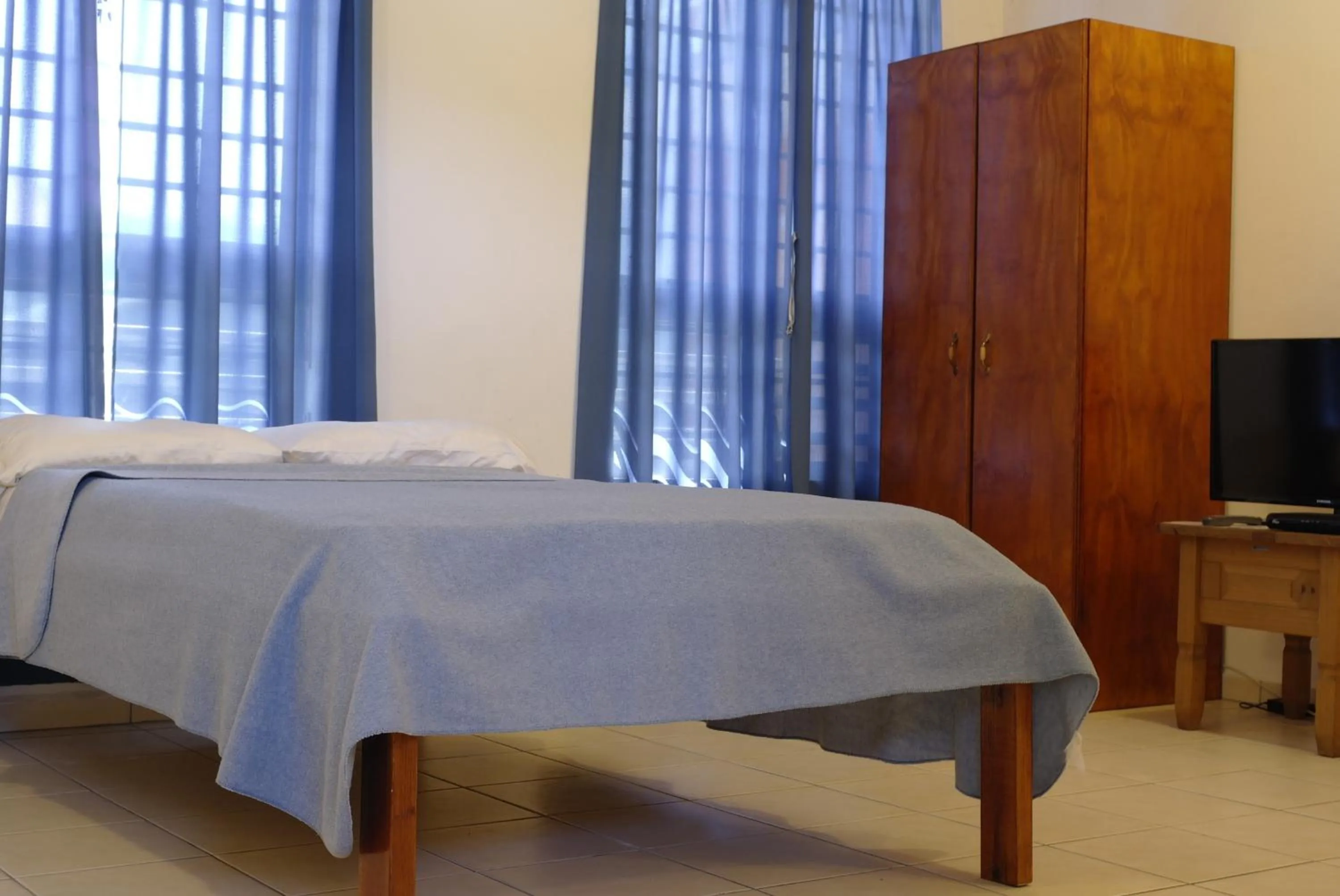 Bed in Orange Rembrandt Studio Apartments