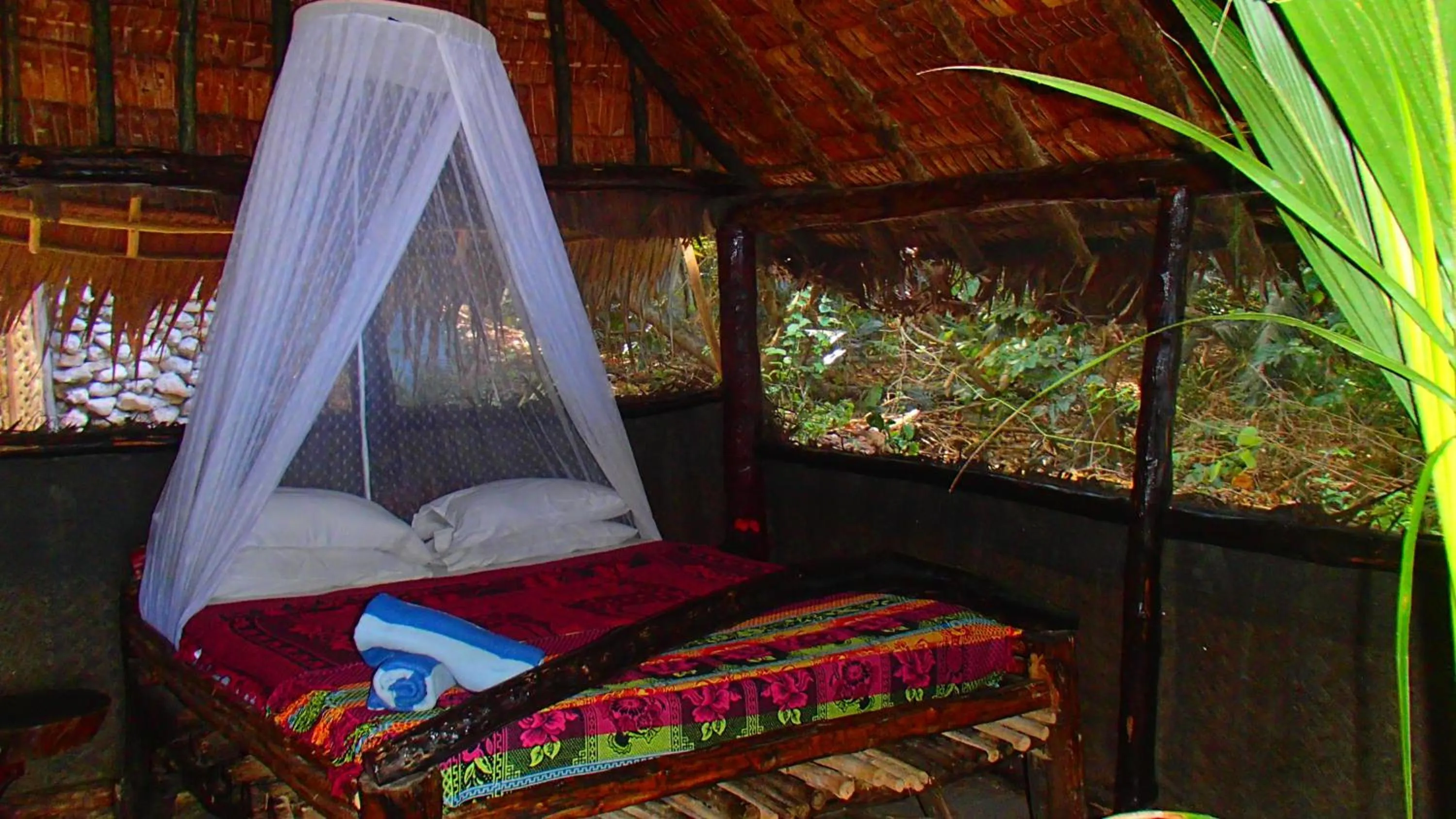 Bed in Tranquility Island Eco Dive Resort