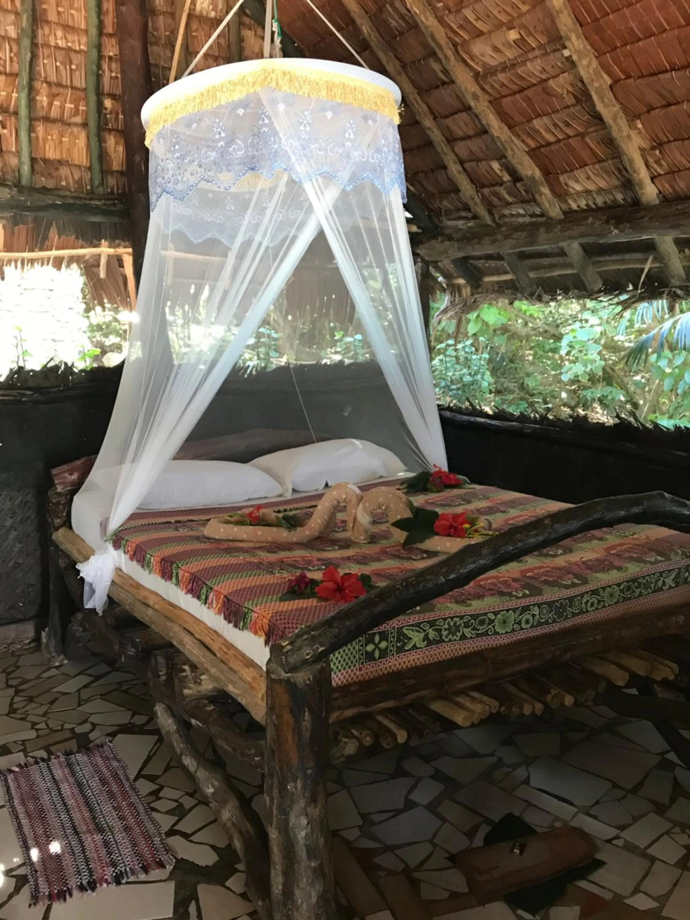 Bed in Tranquility Island Eco Dive Resort