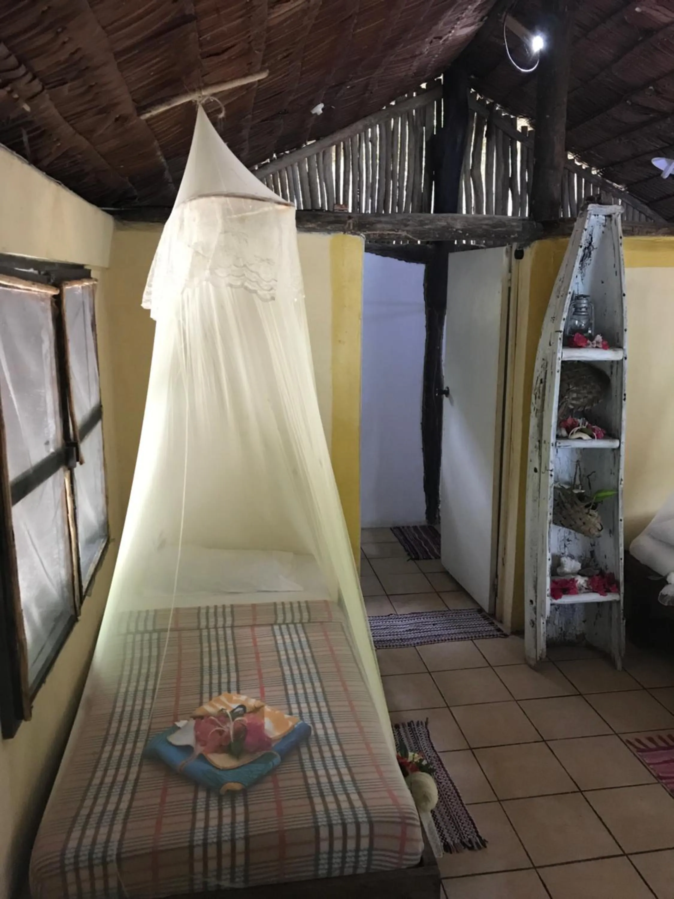 Bed in Tranquility Island Eco Dive Resort