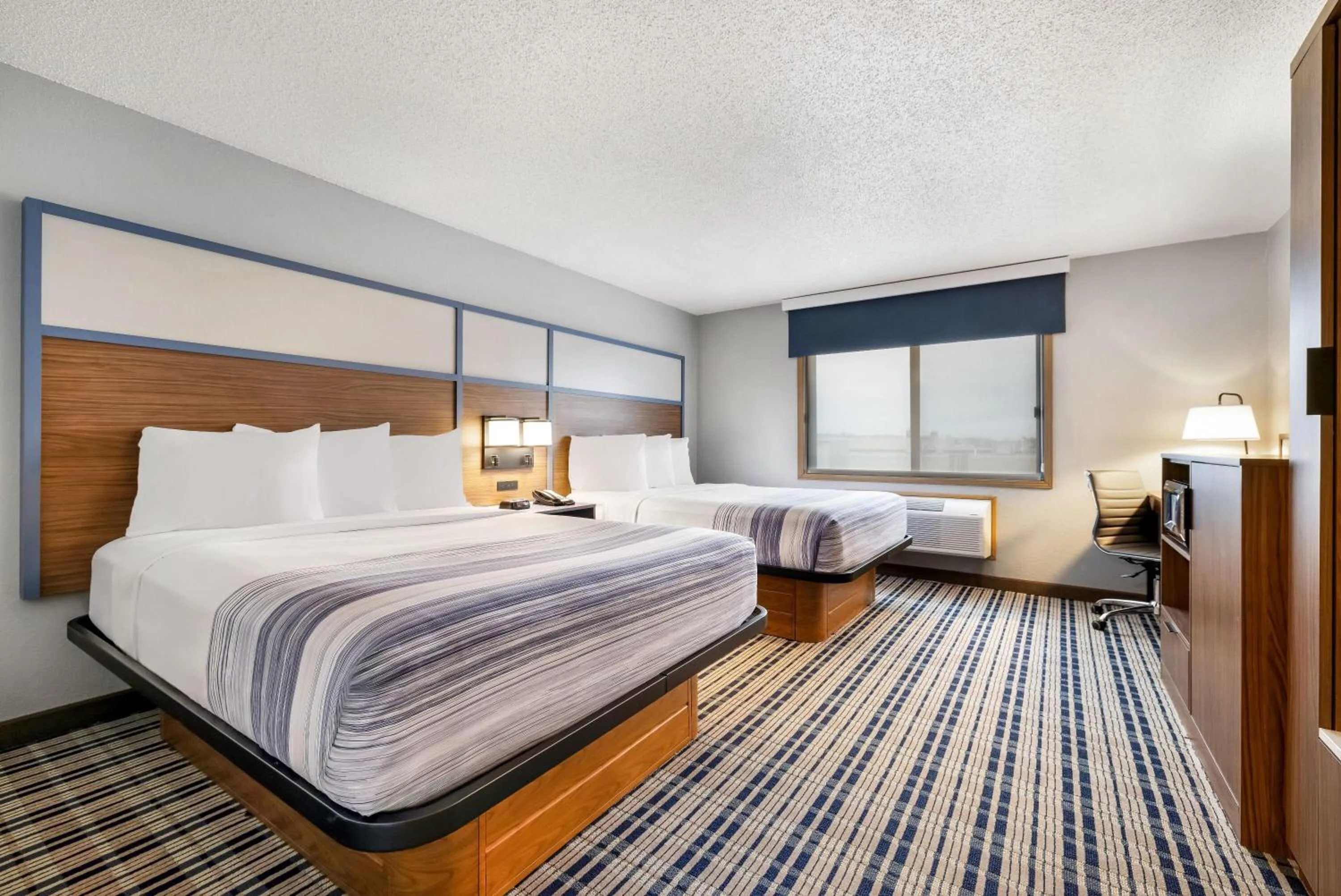 Bed in AmericInn by Wyndham Bismarck