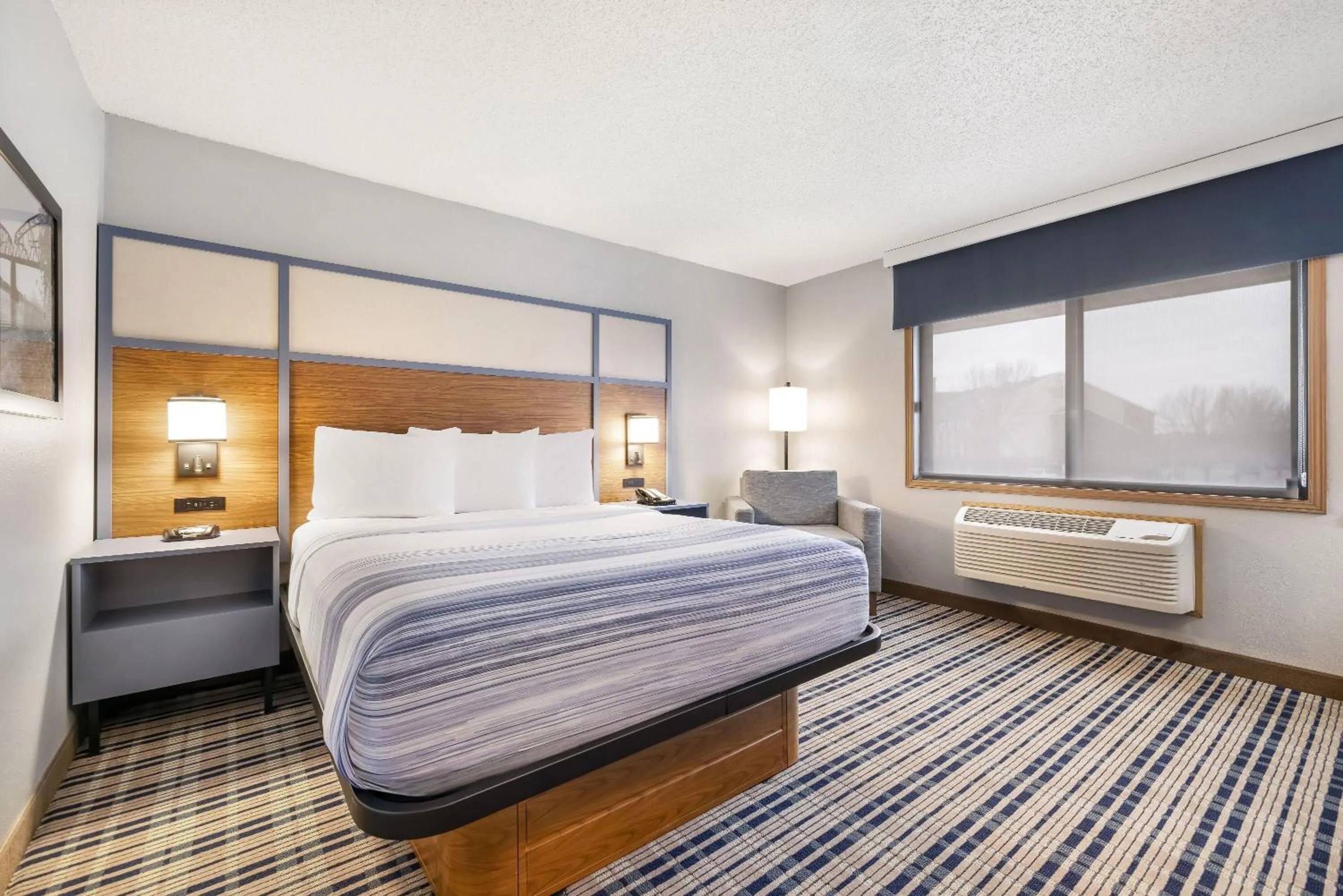 Bed in AmericInn by Wyndham Bismarck