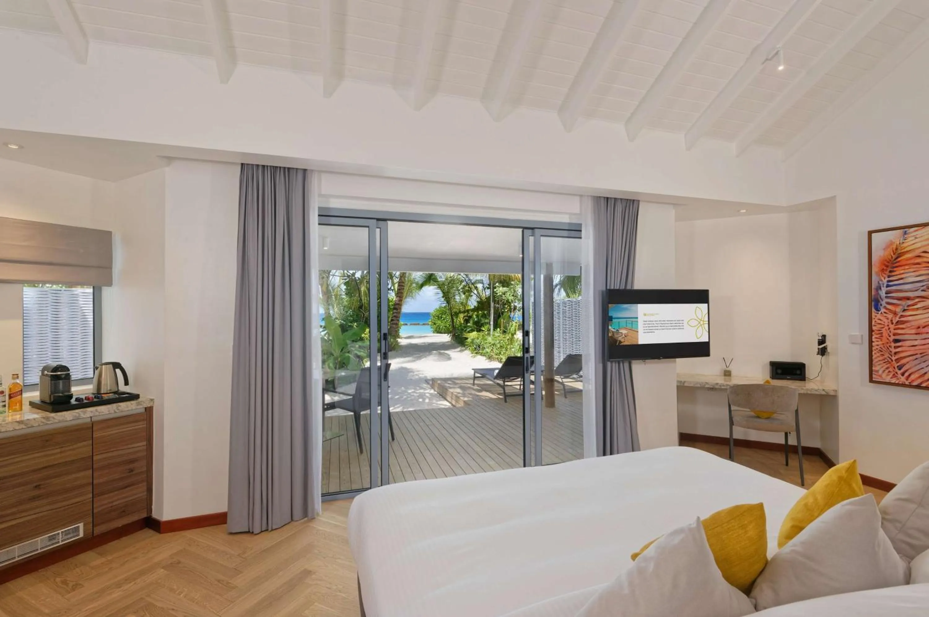 Photo of the whole room, Bed in OUTRIGGER Maldives Maafushivaru Resort - 25 percent discount on transfers for min 4 nights stay and more, valid for reservations between 01 July till 22 Dec 2025