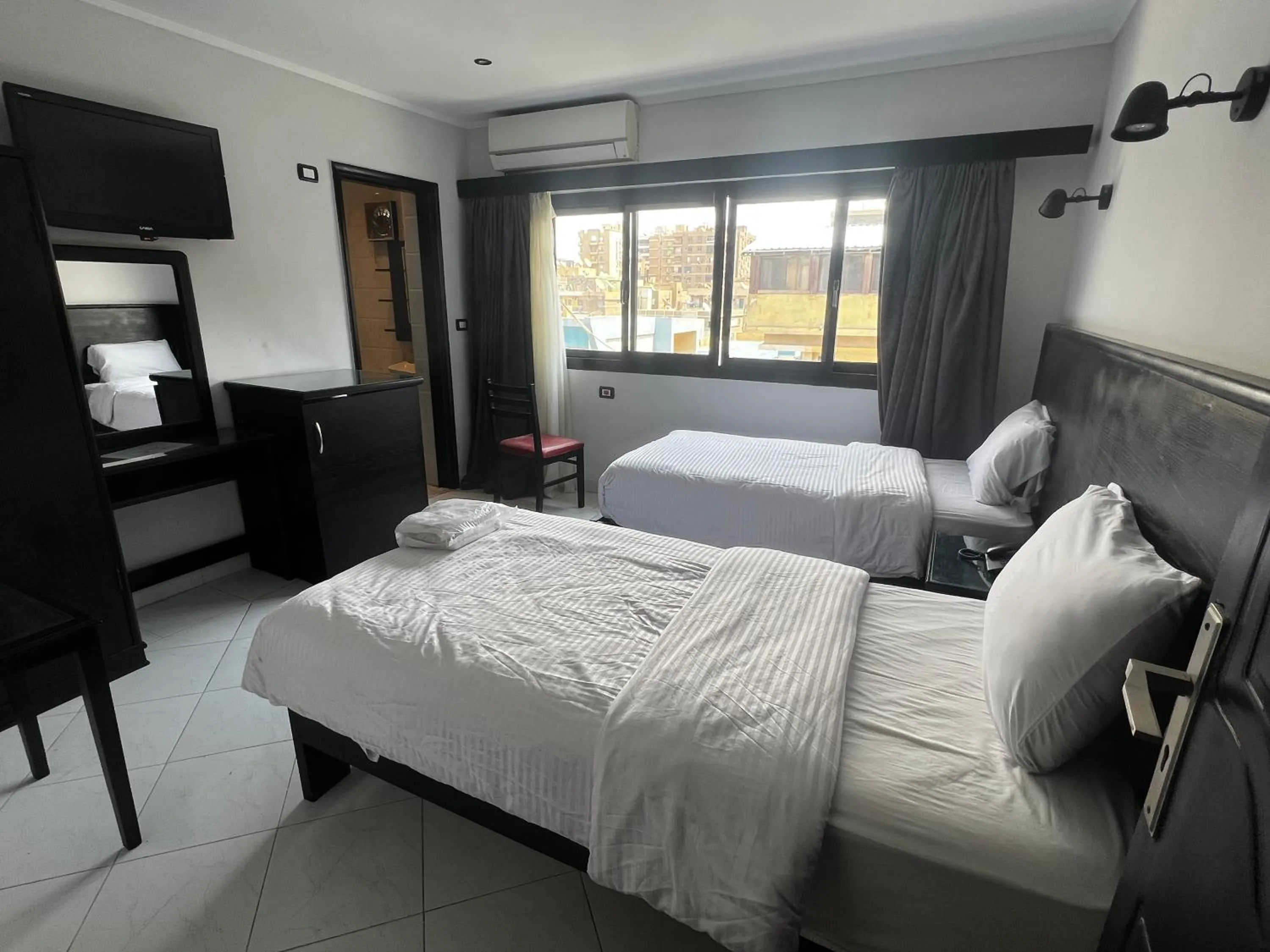 Bed in Helio Cairo Hotel