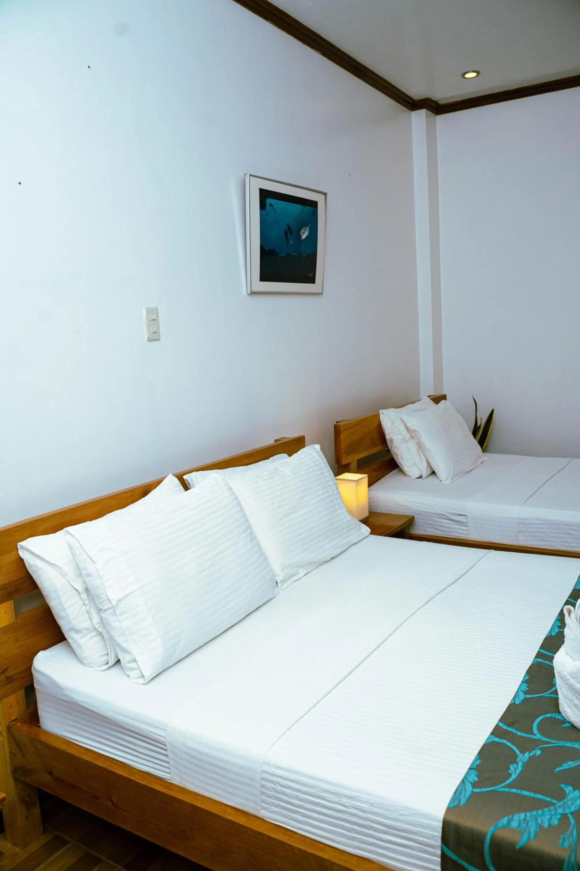 Bed in DiveGurus Boracay Beach Resort