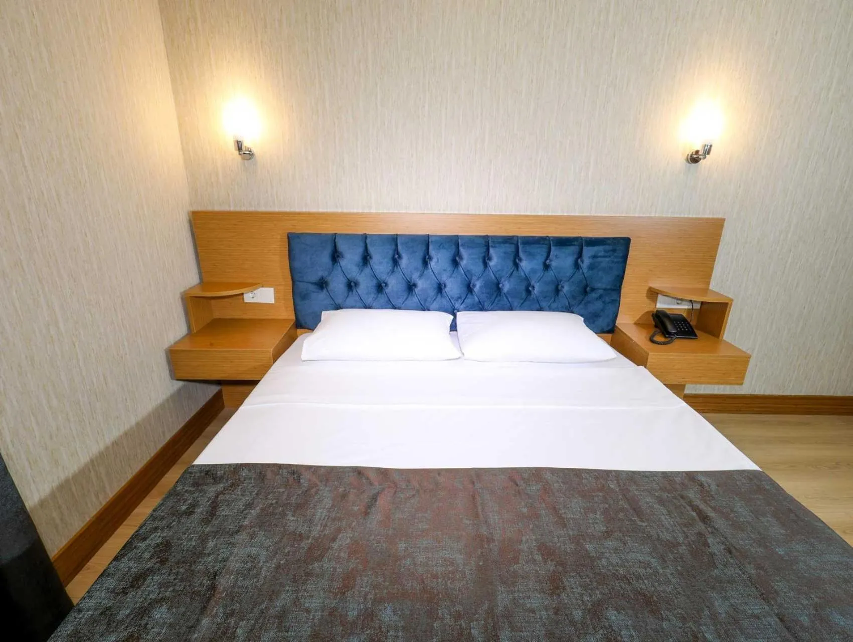 Bed in Grand Elmira Suites