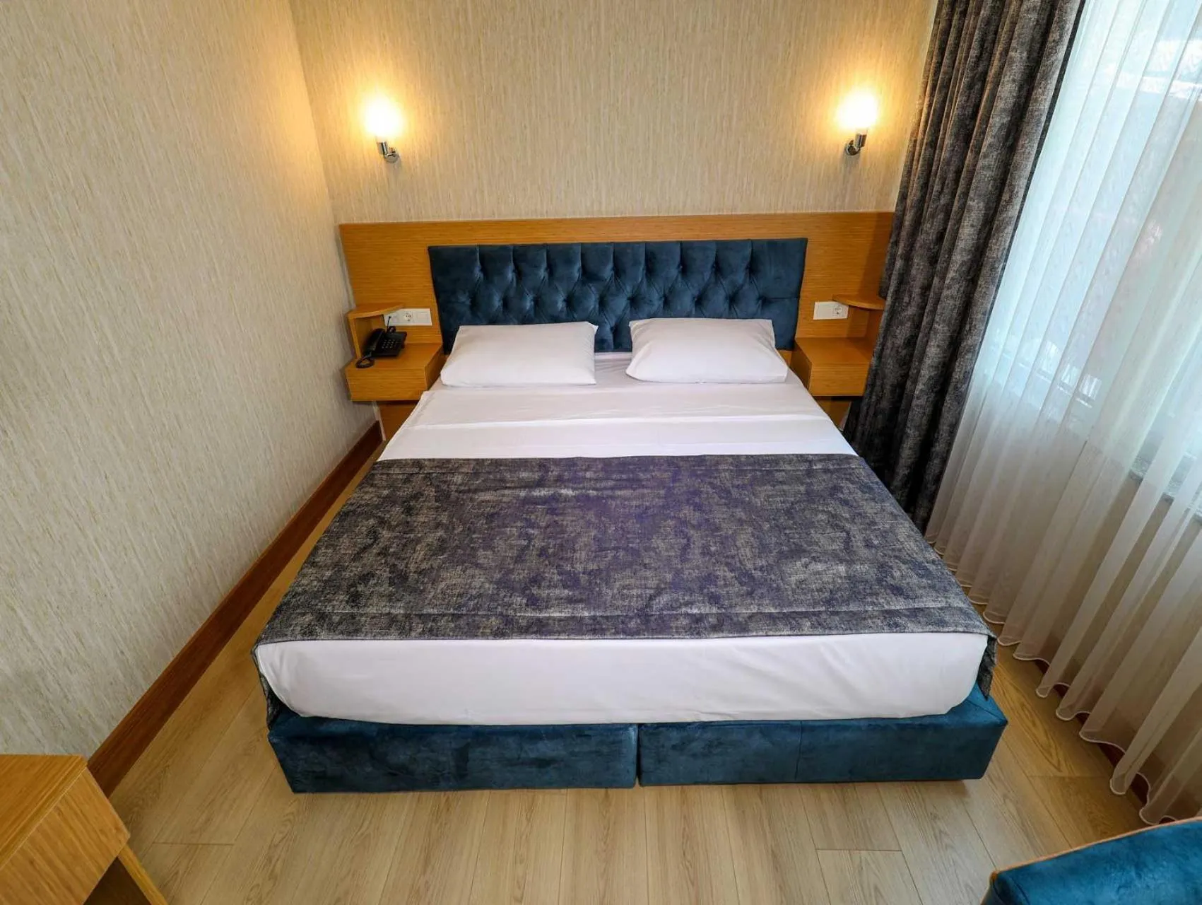 Bed in Grand Elmira Suites