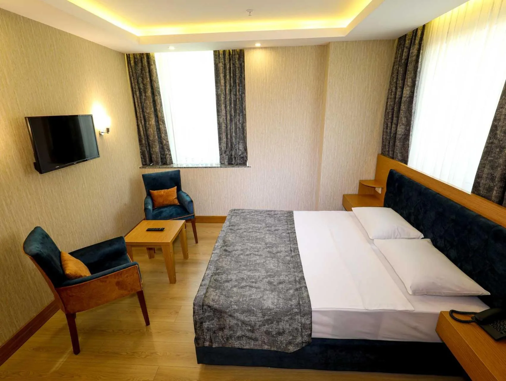 Bed in Grand Elmira Suites