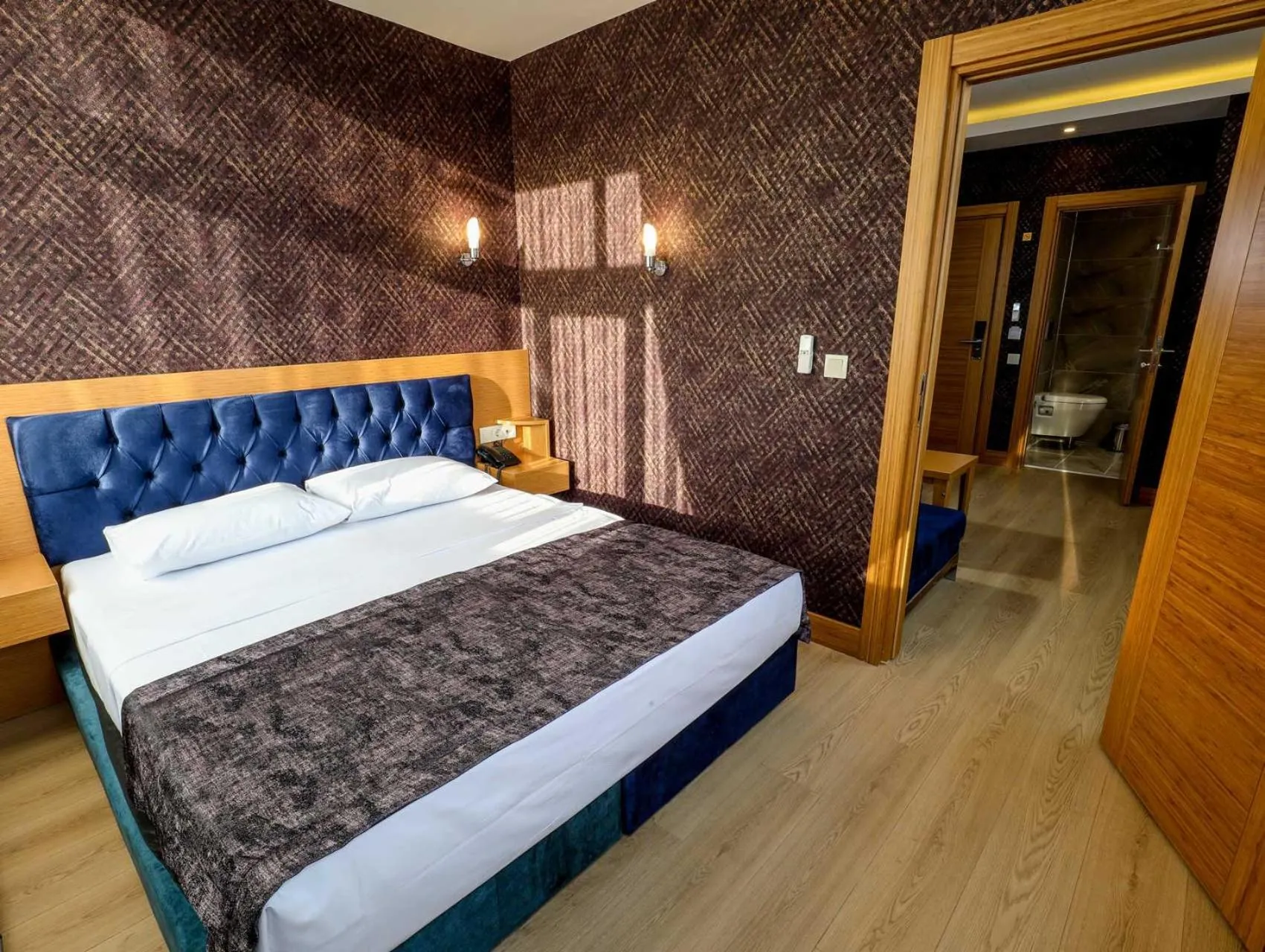 Bed in Grand Elmira Suites