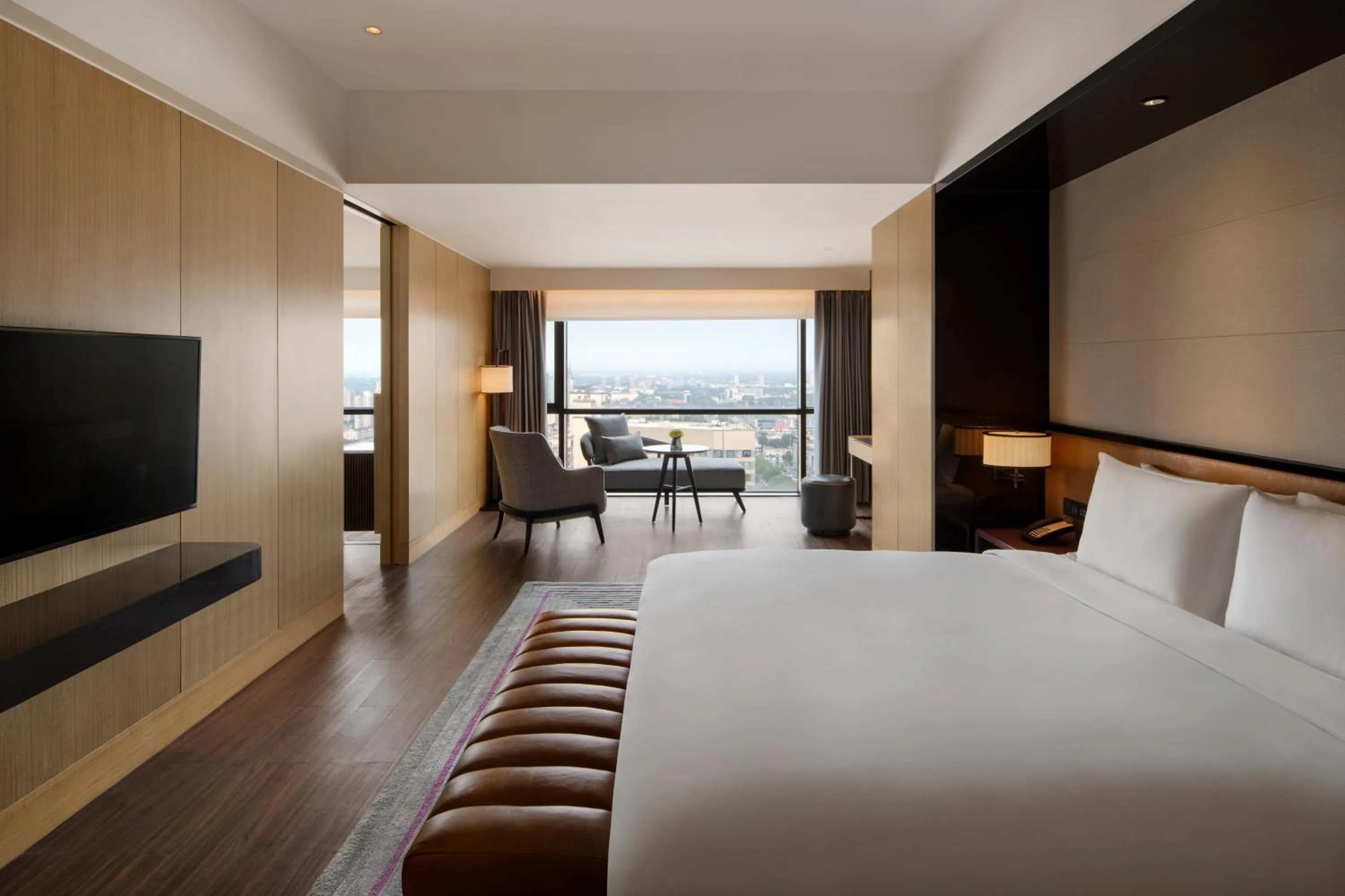 Bed in New World Langfang Hotel