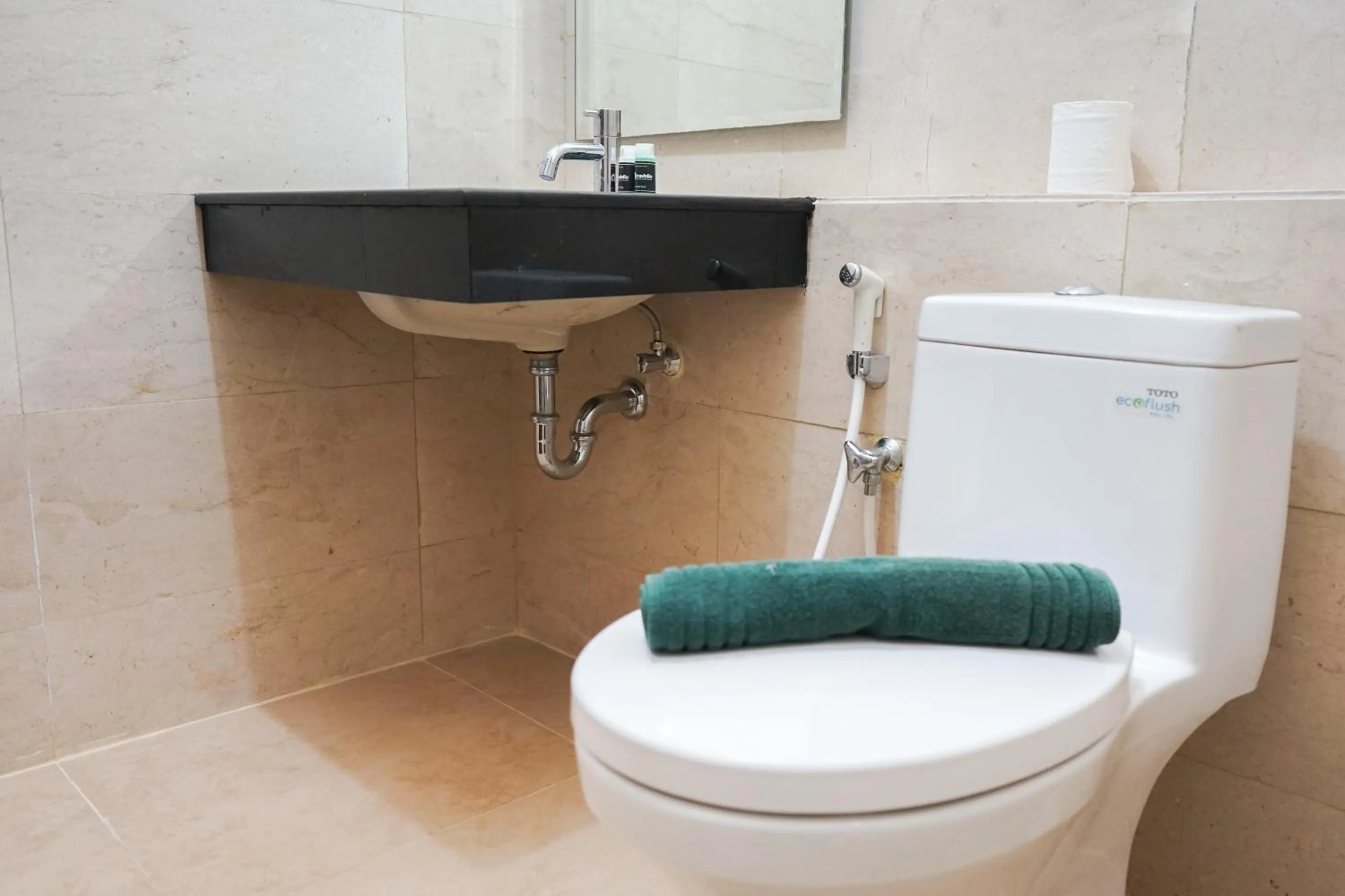 Bathroom in South Tower 2BR at L'Avenue Apartment By Travelio