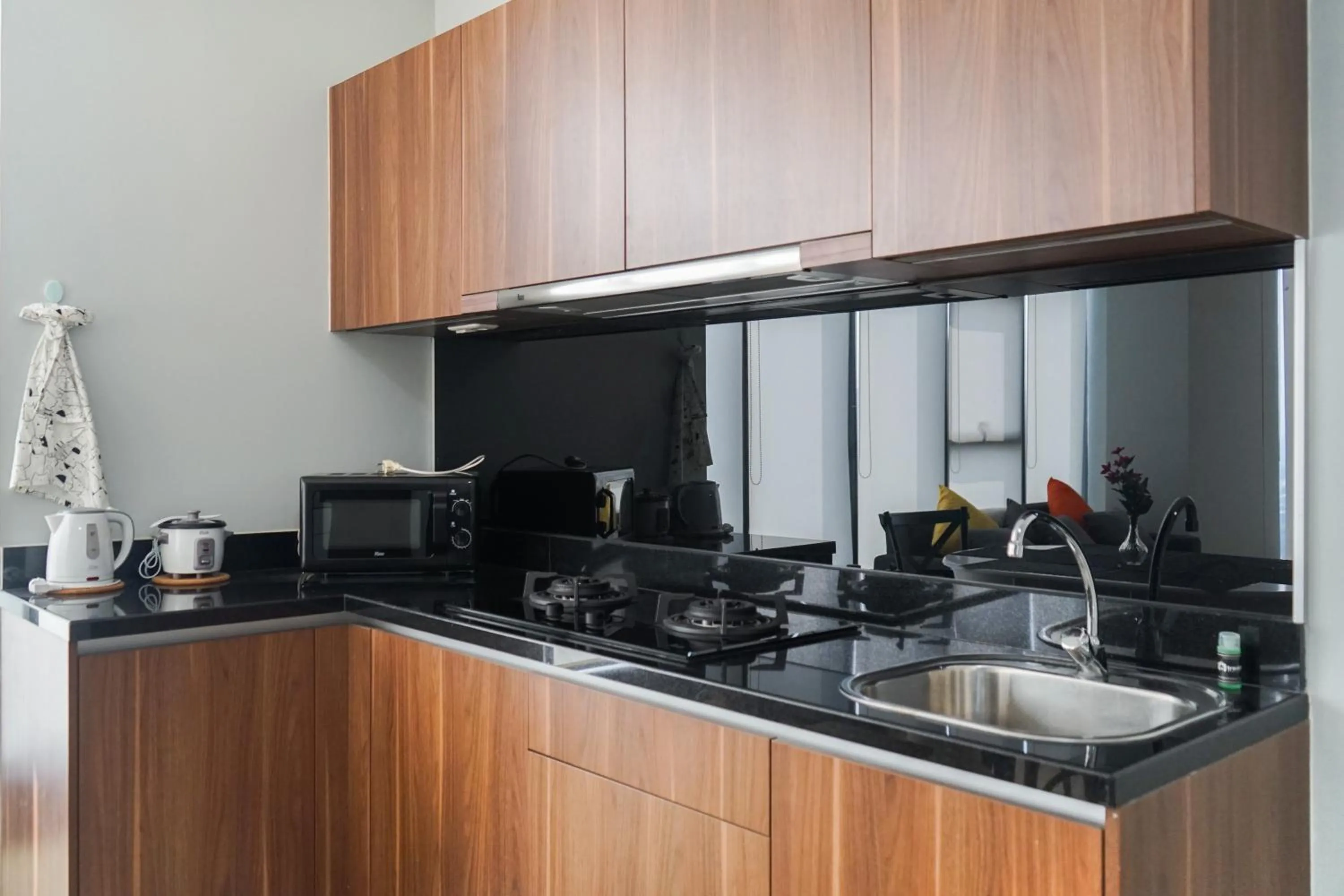 Kitchen or kitchenette in South Tower 2BR at L'Avenue Apartment By Travelio