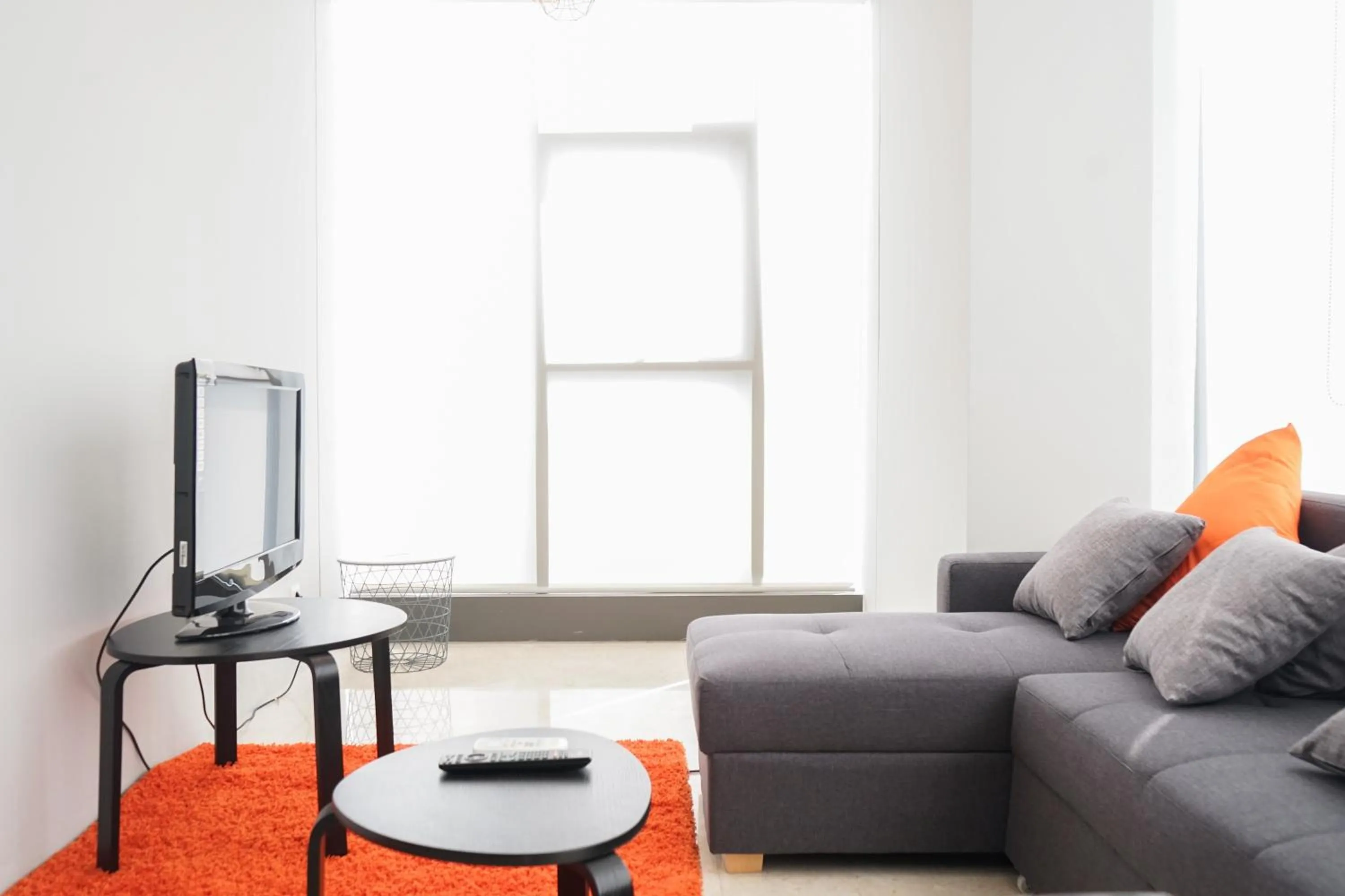 Living room in South Tower 2BR at L'Avenue Apartment By Travelio