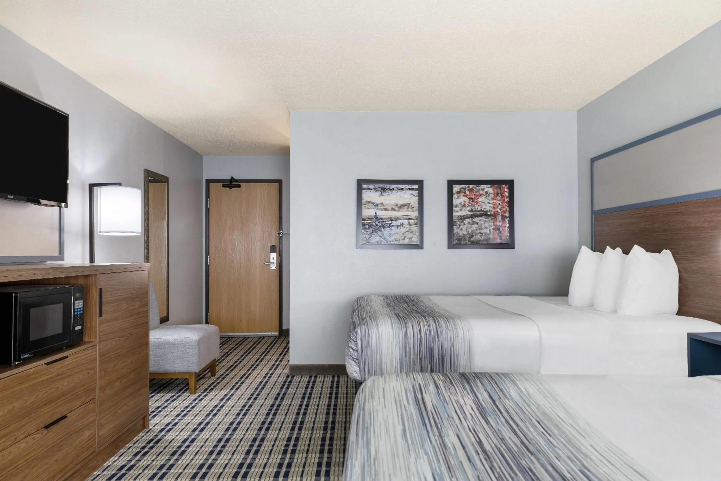 Bed in AmericInn by Wyndham Chamberlain Conference Center