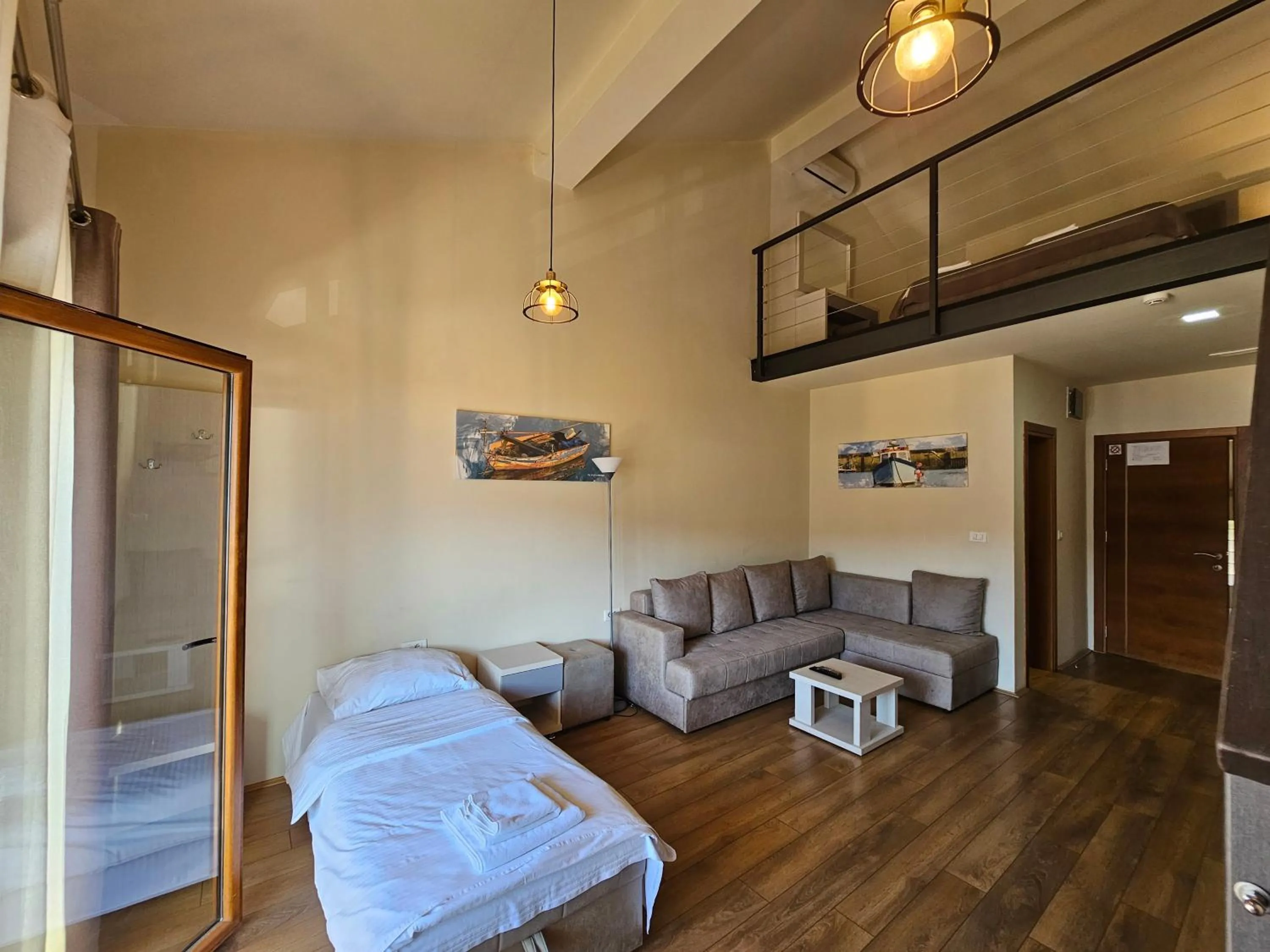 Living room, Bed in Hotel Olimpija plus