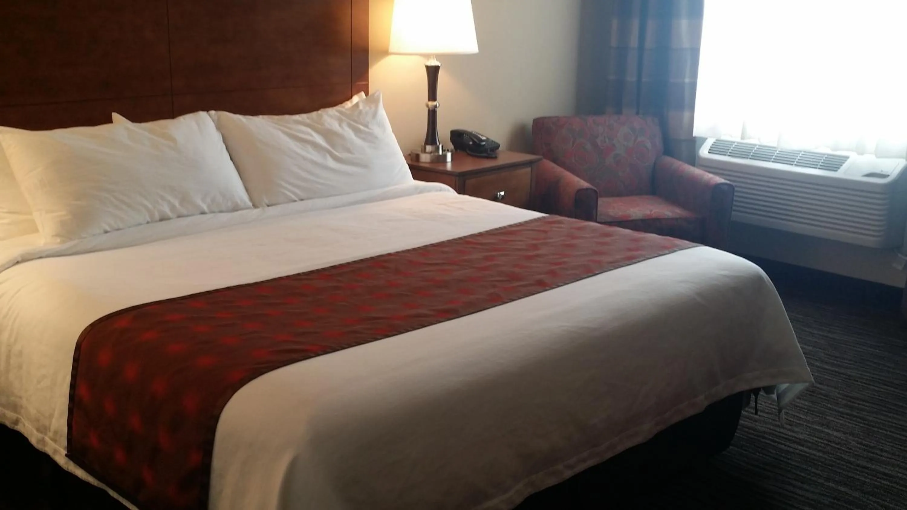 Bed in American Inn & Suites