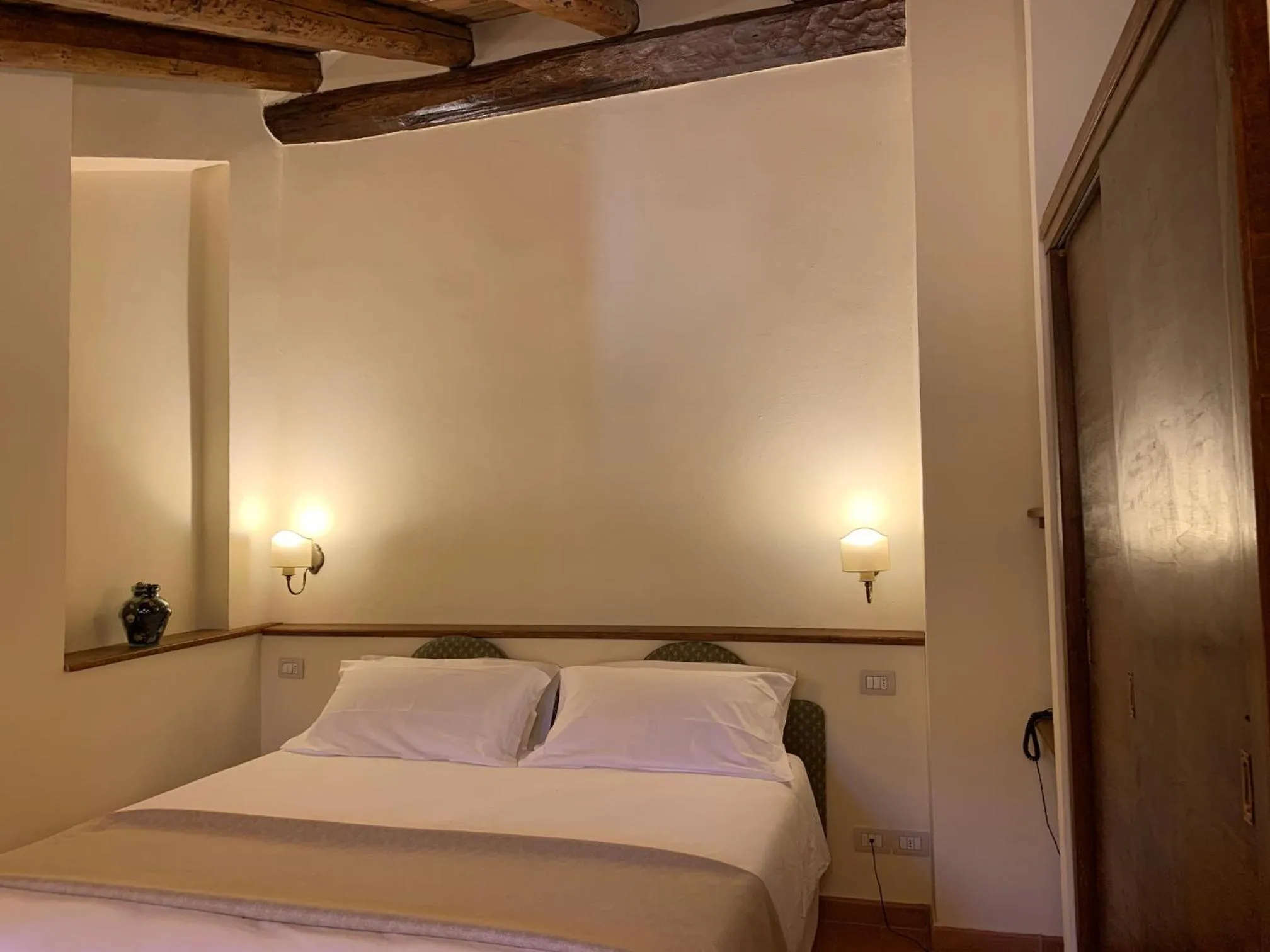 Bed in PALAZZO DE' ROSSI HOTEL