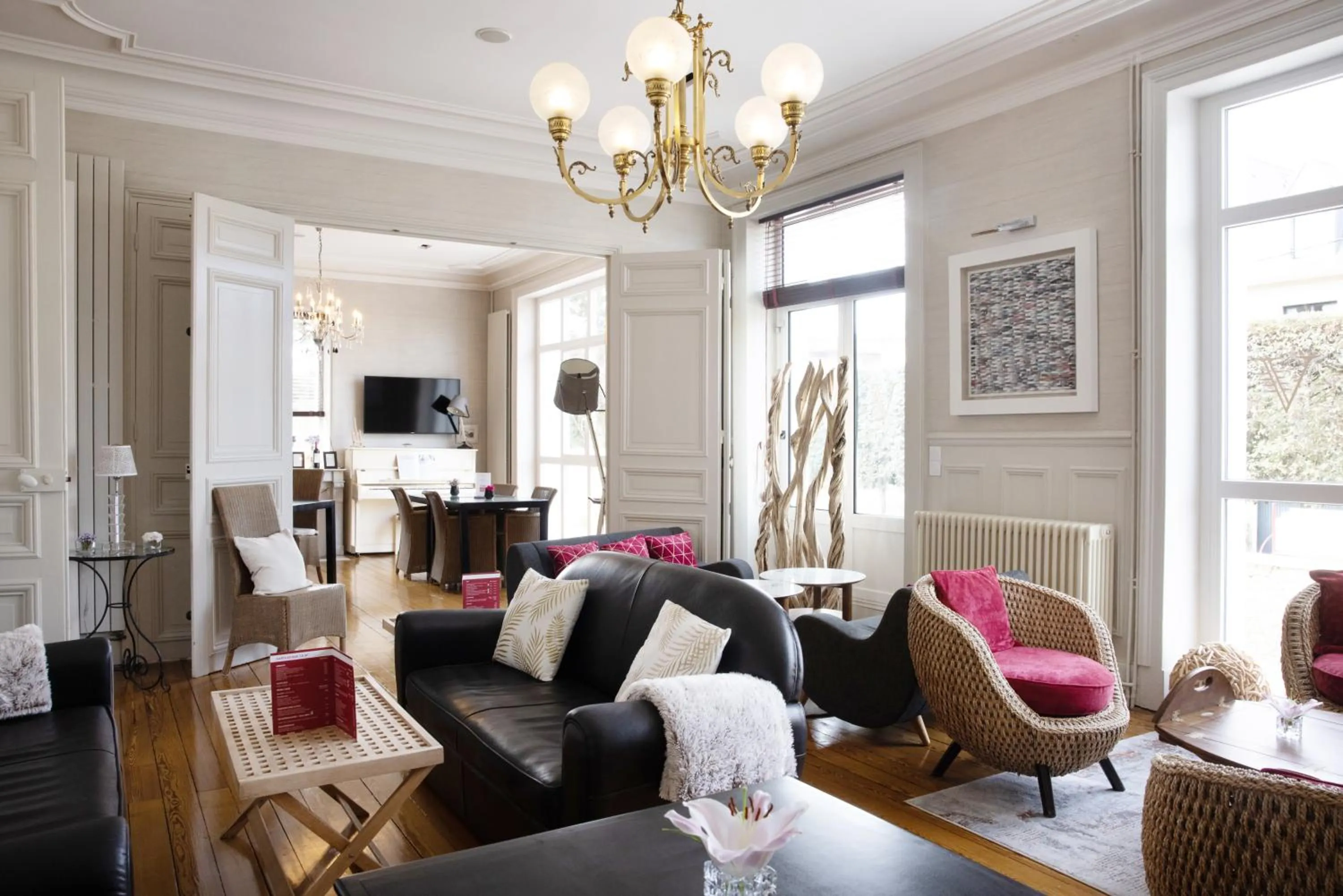 Communal lounge/ TV room in Hôtel La Villefromoy