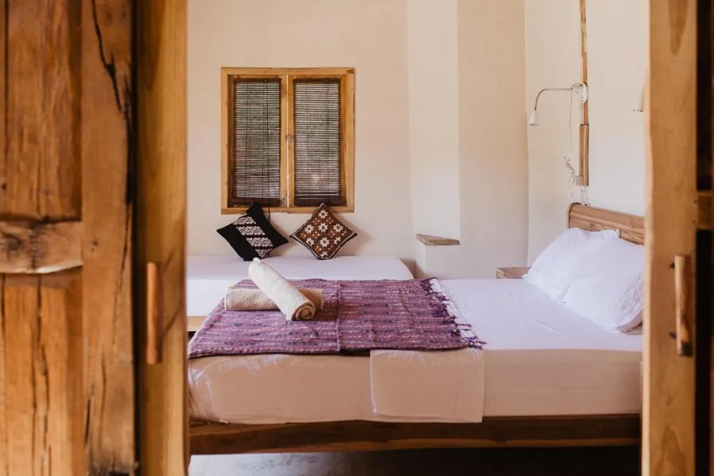 Bed in Kalyssa Beach Bungalows