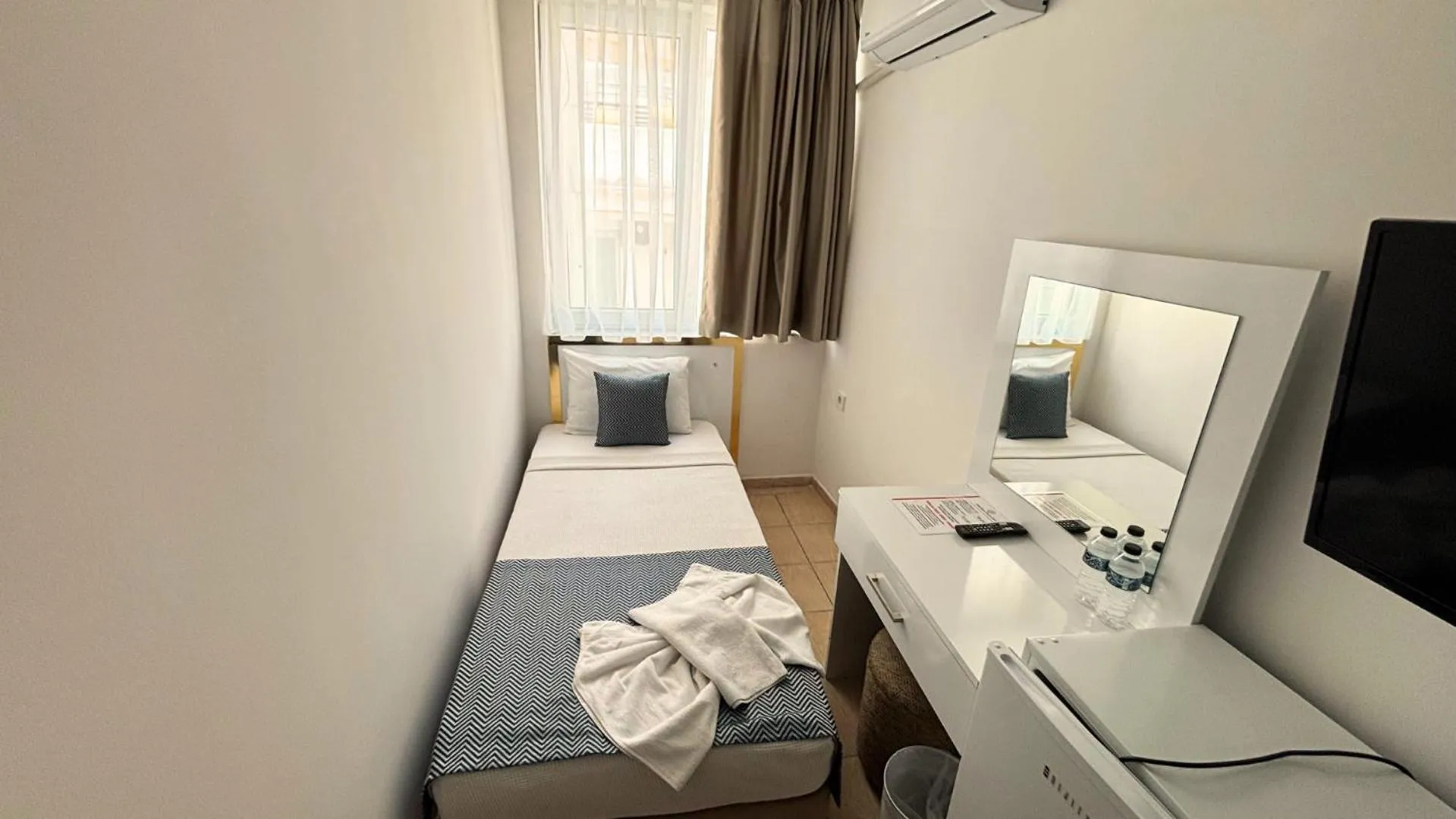 Bed in MOONBOW BEACH HOTEL