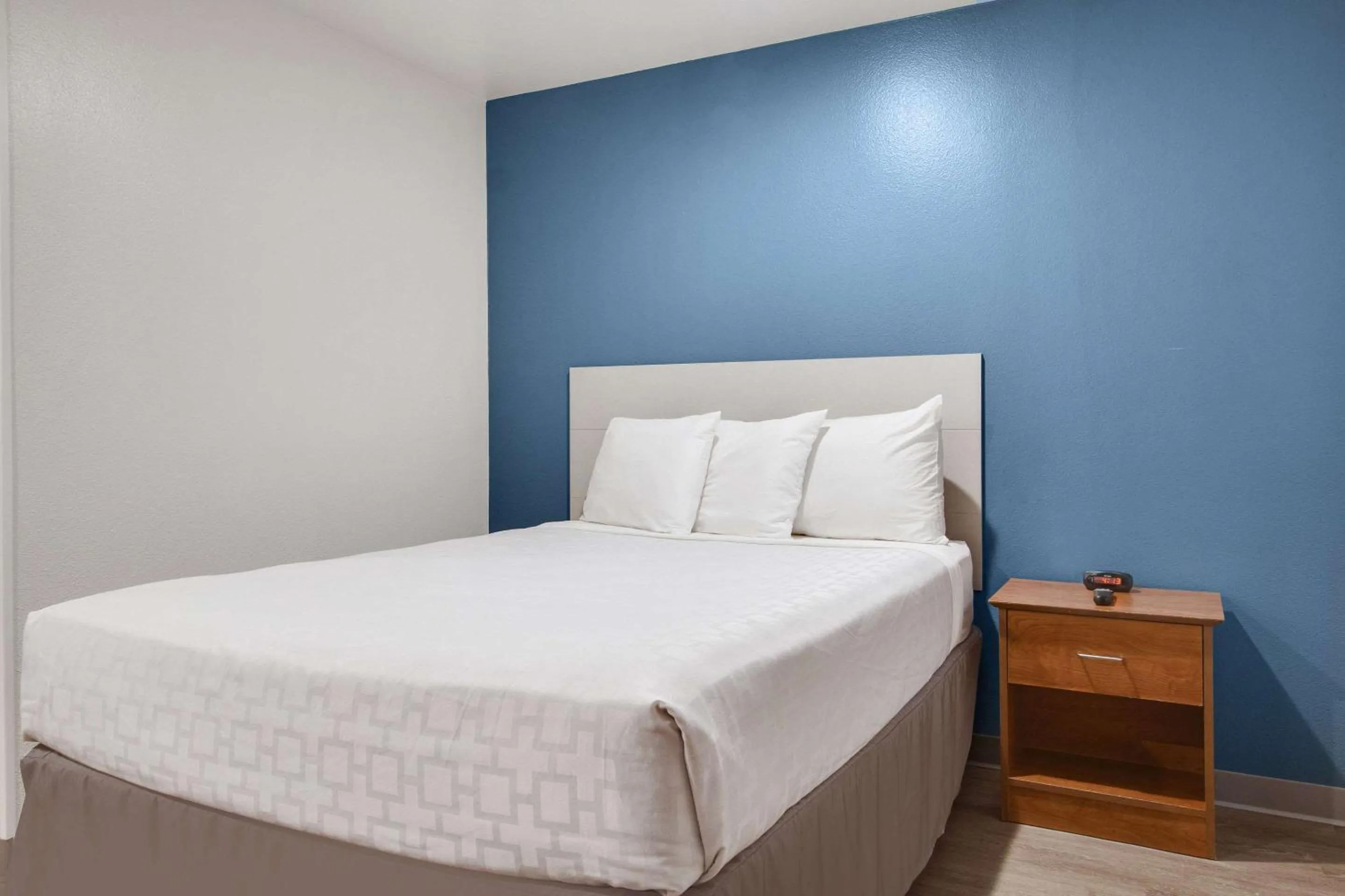 Bedroom, Bed in WoodSpring Suites Conroe