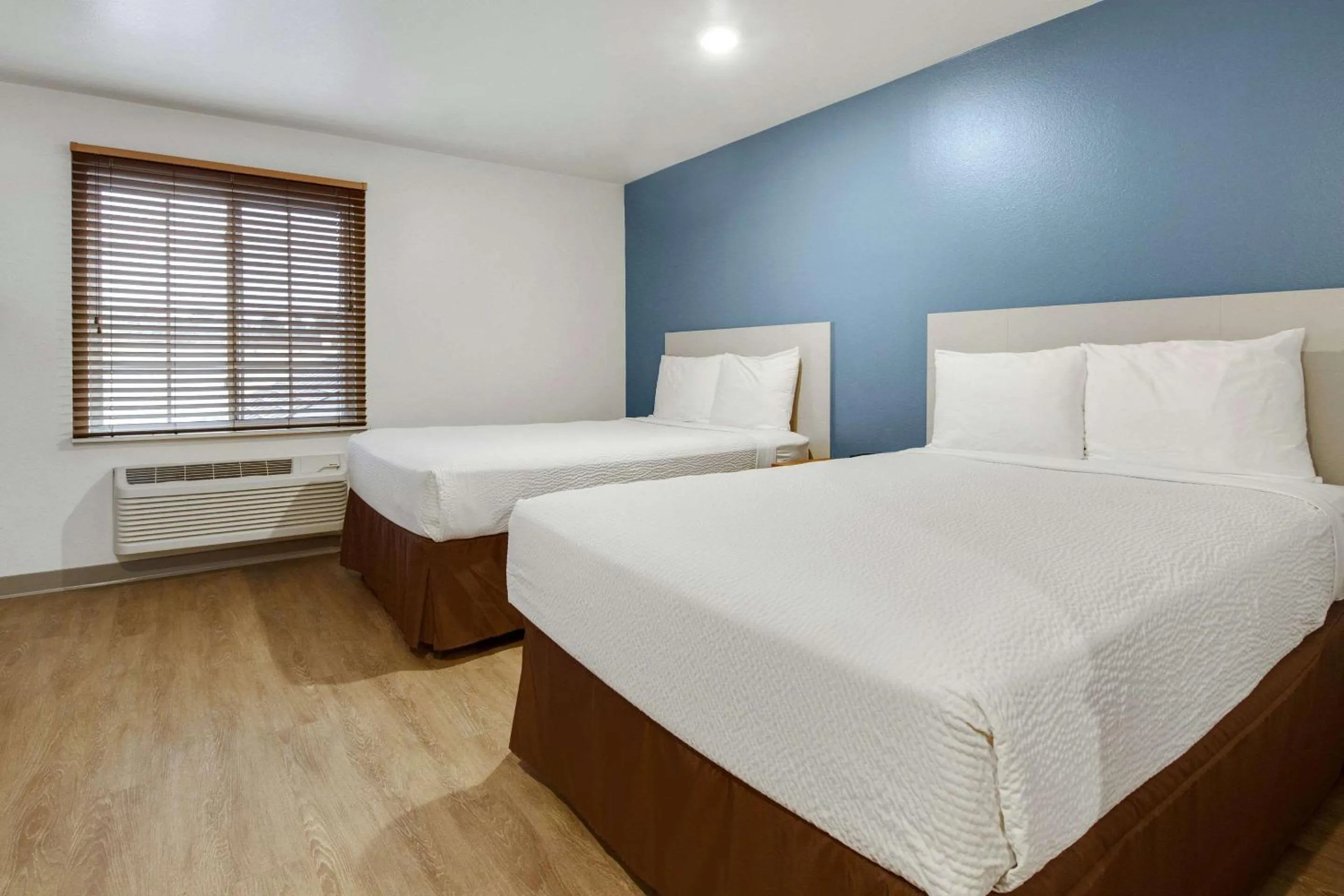 Bedroom, Bed in WoodSpring Suites Conroe