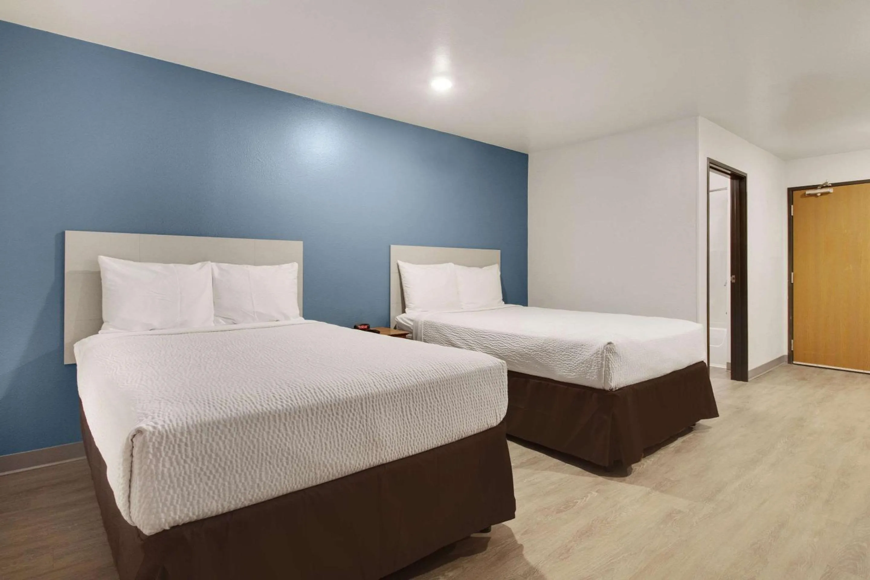 Bedroom, Bed in WoodSpring Suites Conroe