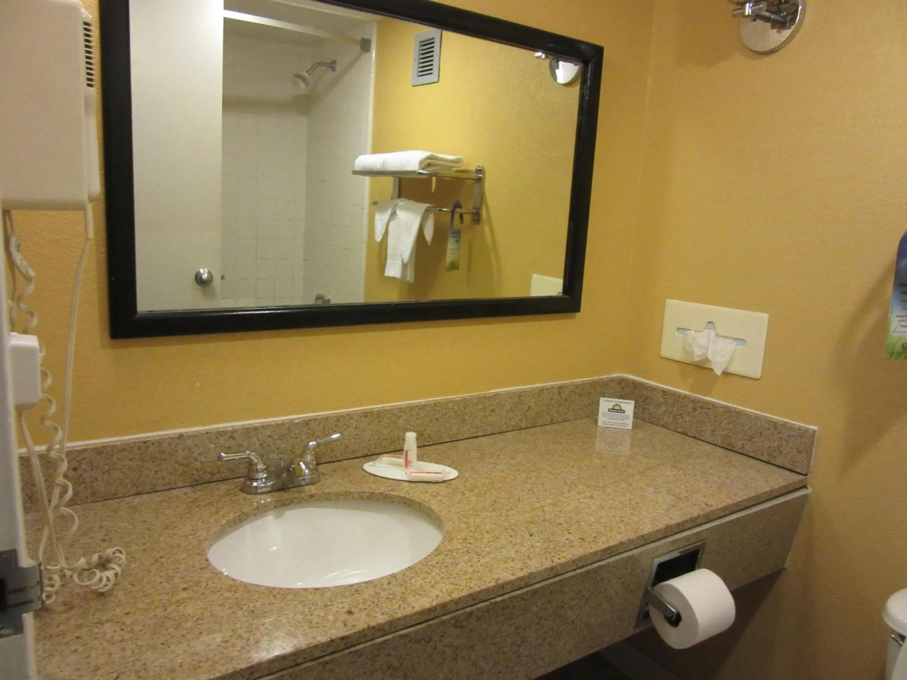 Bathroom in Days Inn & Suites by Wyndham SE Columbia Ft Jackson