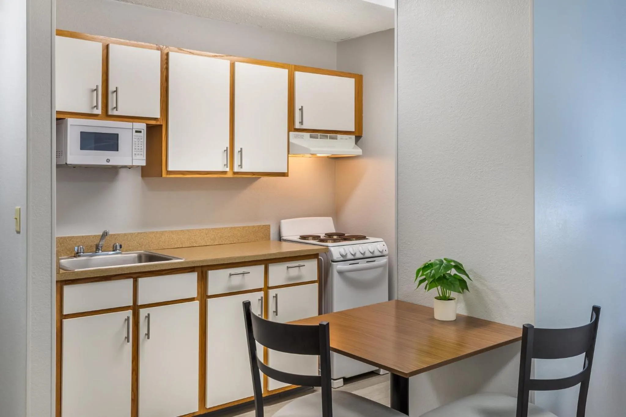 Kitchen or kitchenette in HomeTowne Studios & Suites by Red Roof Greensboro