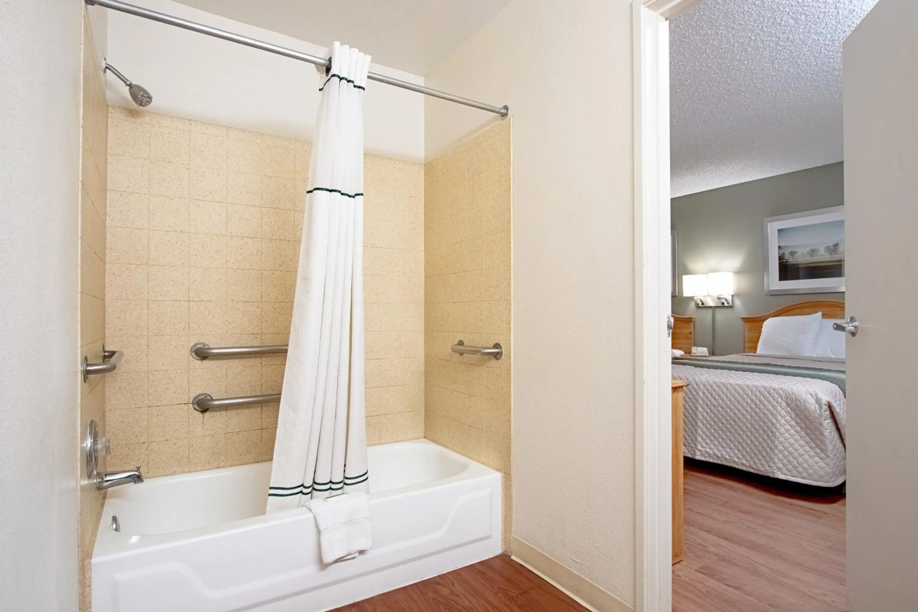 Bathroom, Bed in HomeTowne Studios by Red Roof Phoenix - Dunlap Ave