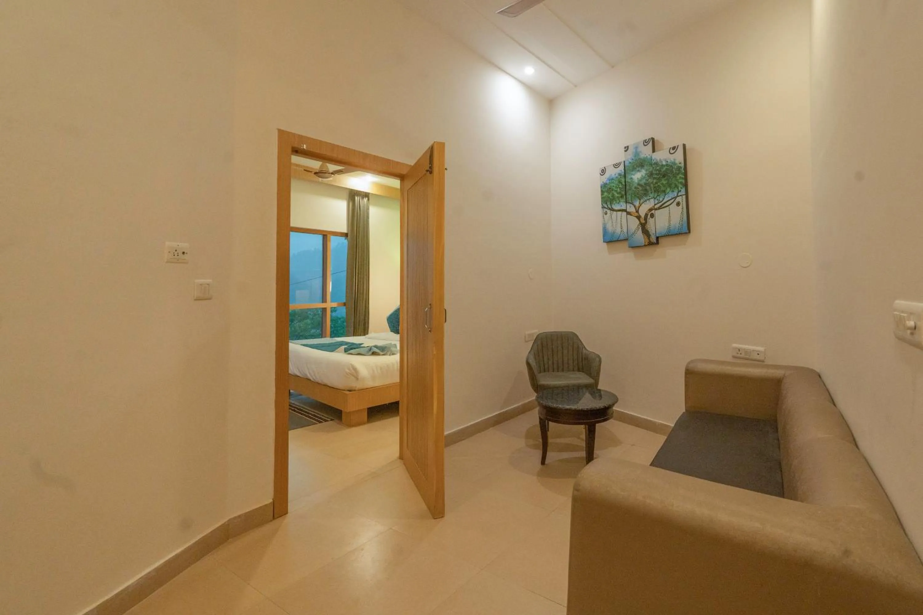 Seating area, Bed in Excel Hotels and Resorts Bhimtal