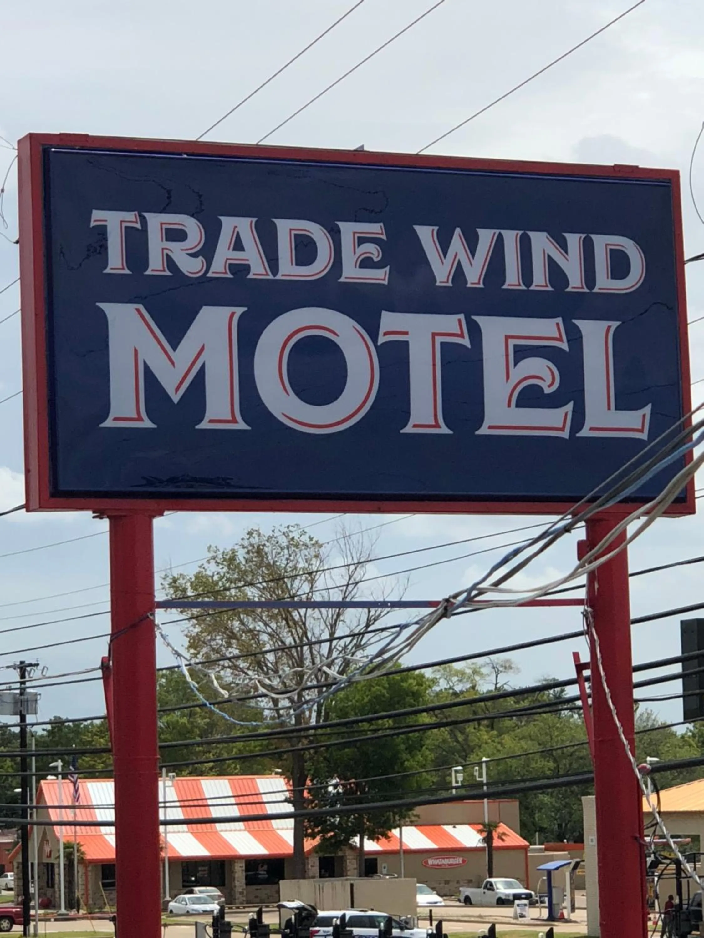 Property logo or sign in Trade Wind Motel