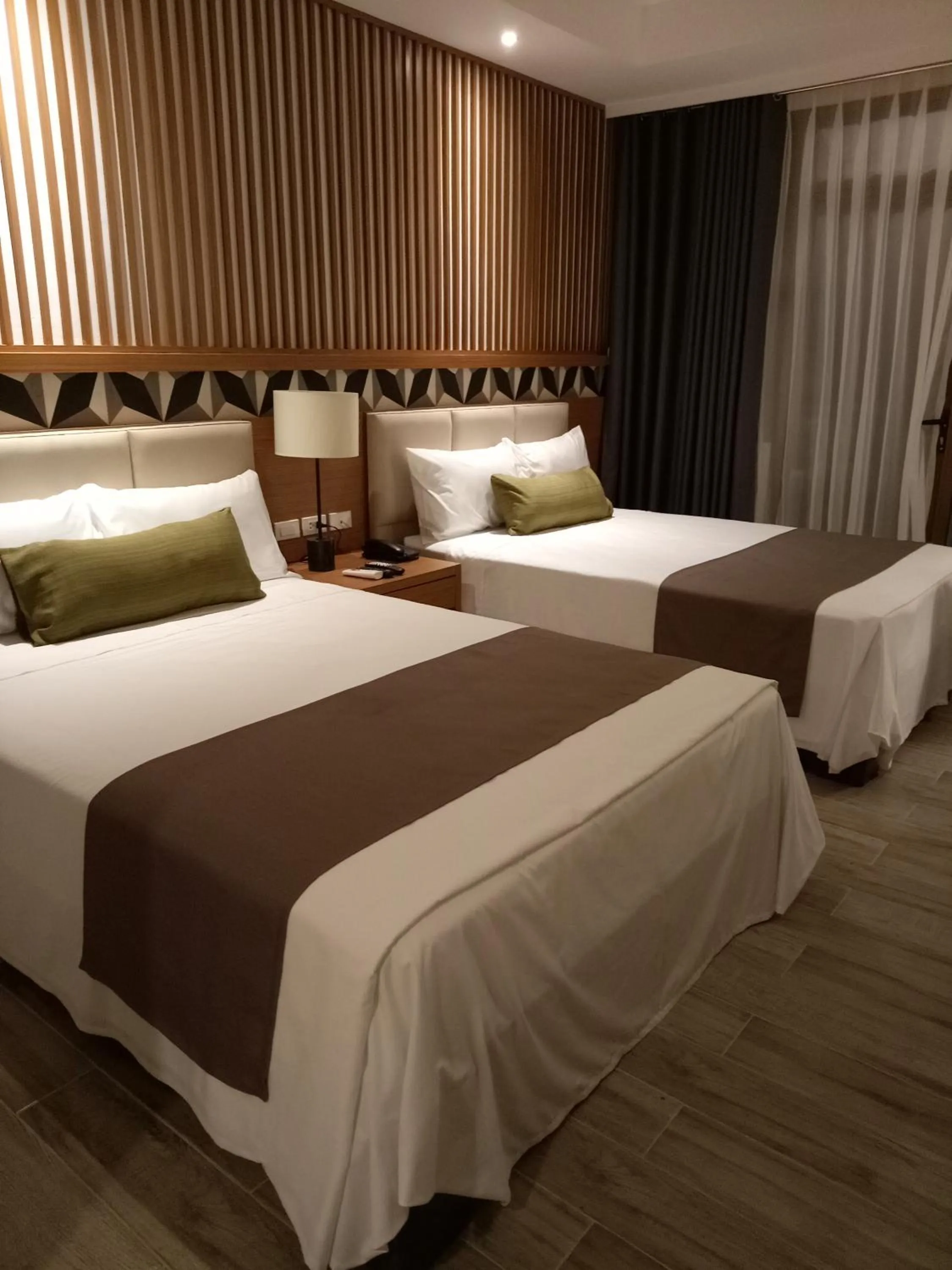 Bed in Crown Hotel at Harbour Springs Palawan Managed by Enderun Hotels