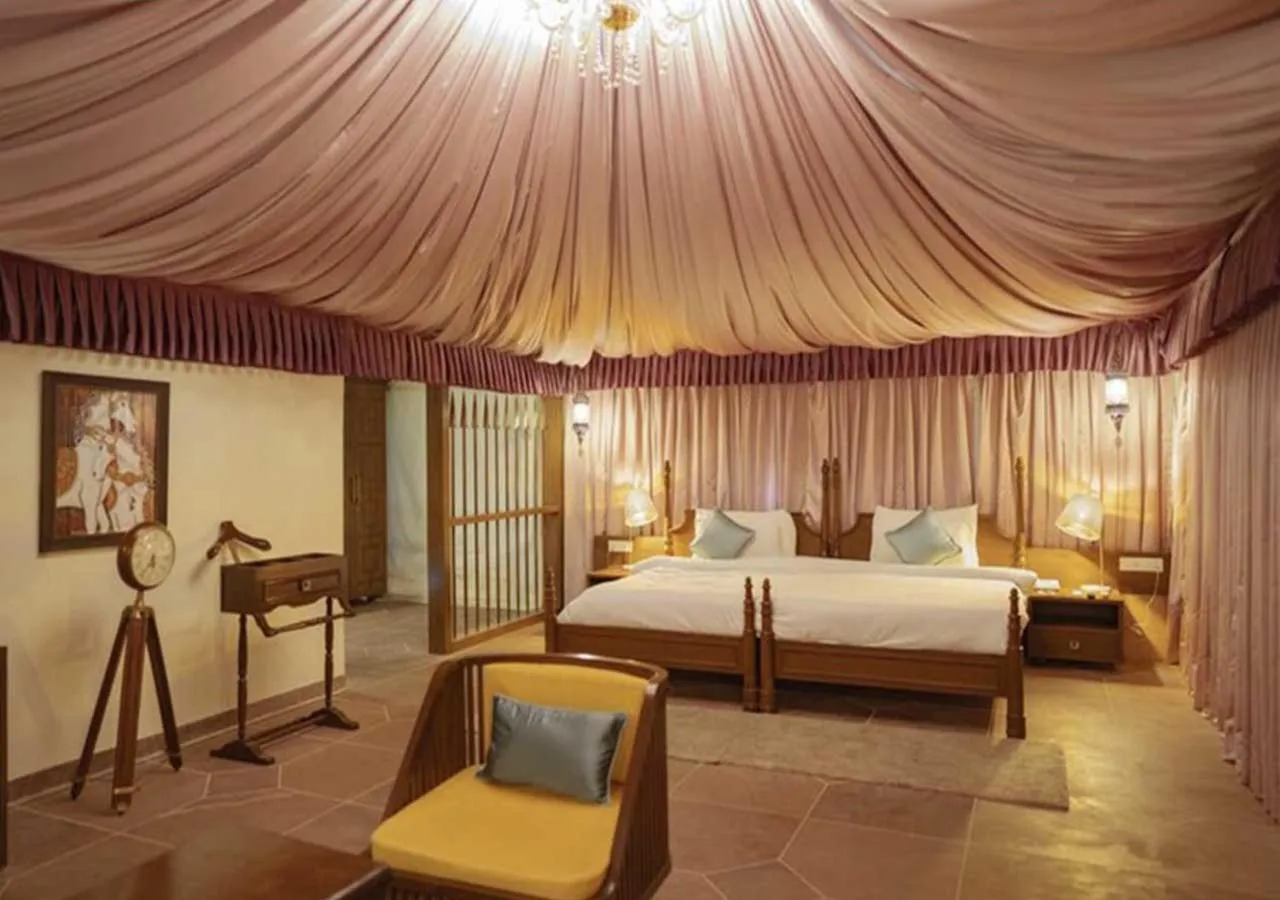 Bed in WelcomHeritage Tadoba Vanya Villas Resort & Spa
