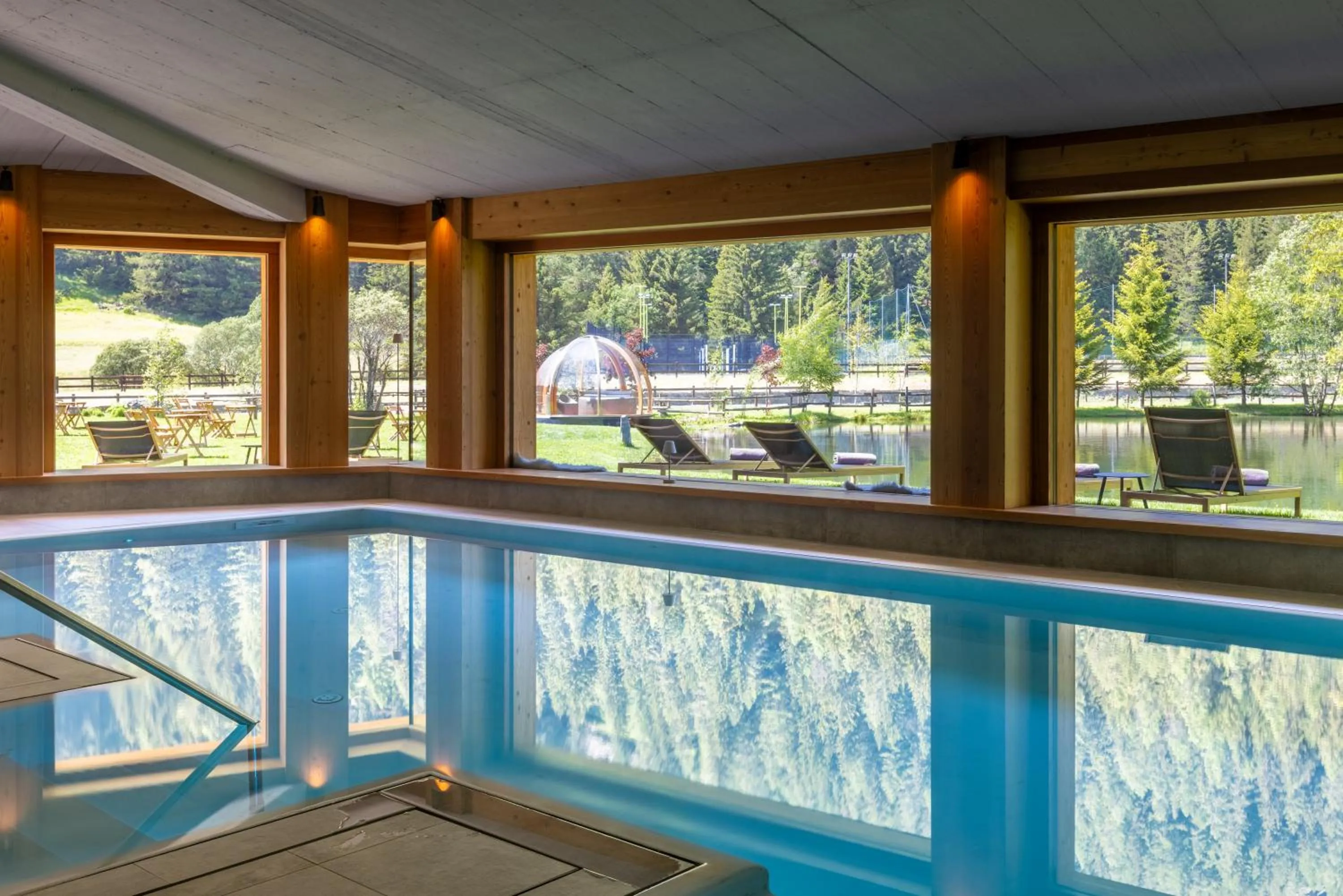 Pool view in Au Charmant Petit Lac - Ecohotel Parc & Spa