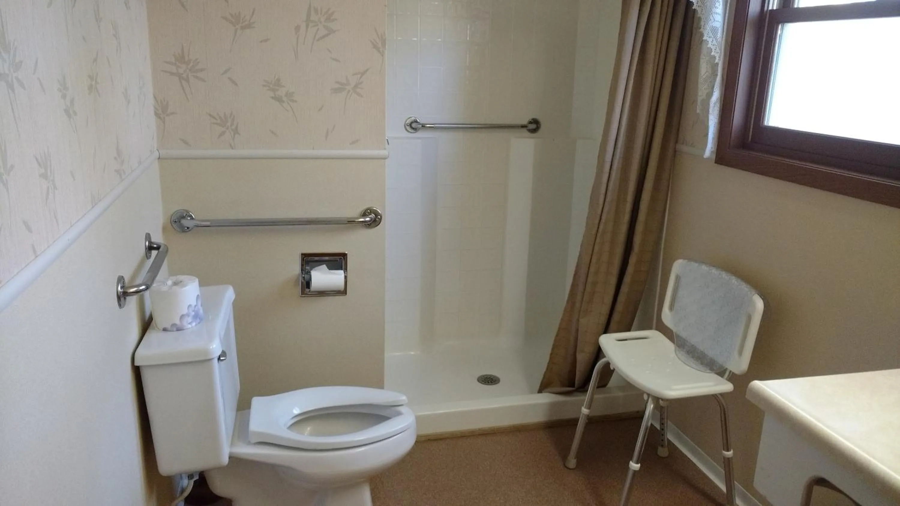 Toilet in Stagecoach Inn & Suites