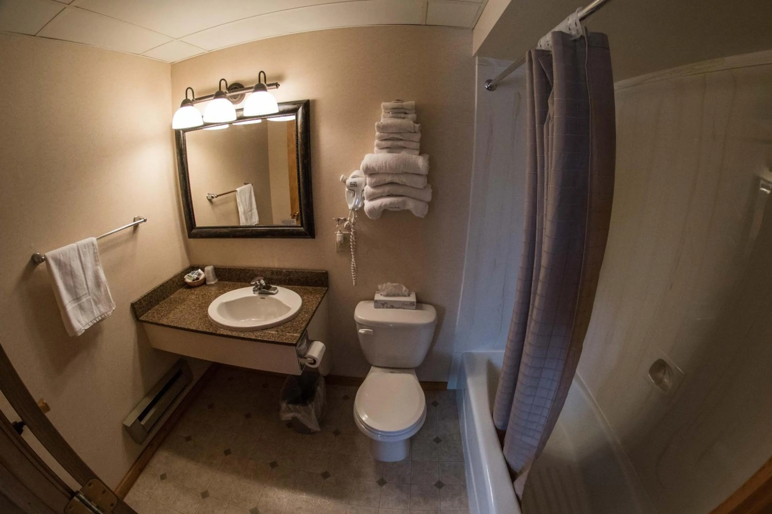 Toilet in Stagecoach Inn & Suites
