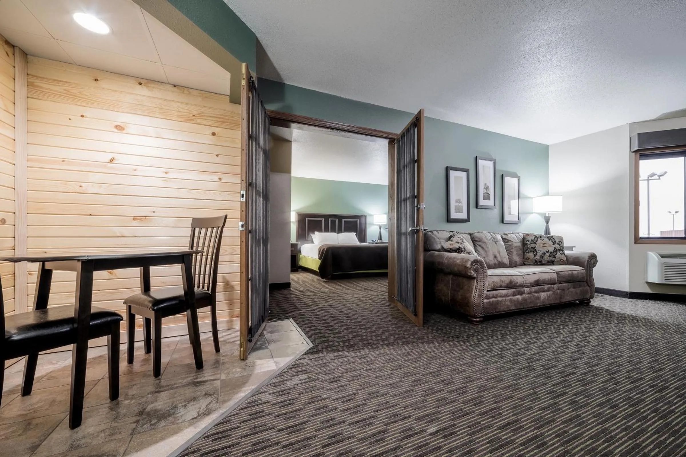 Living room, Bed in AmericInn by Wyndham West Salem