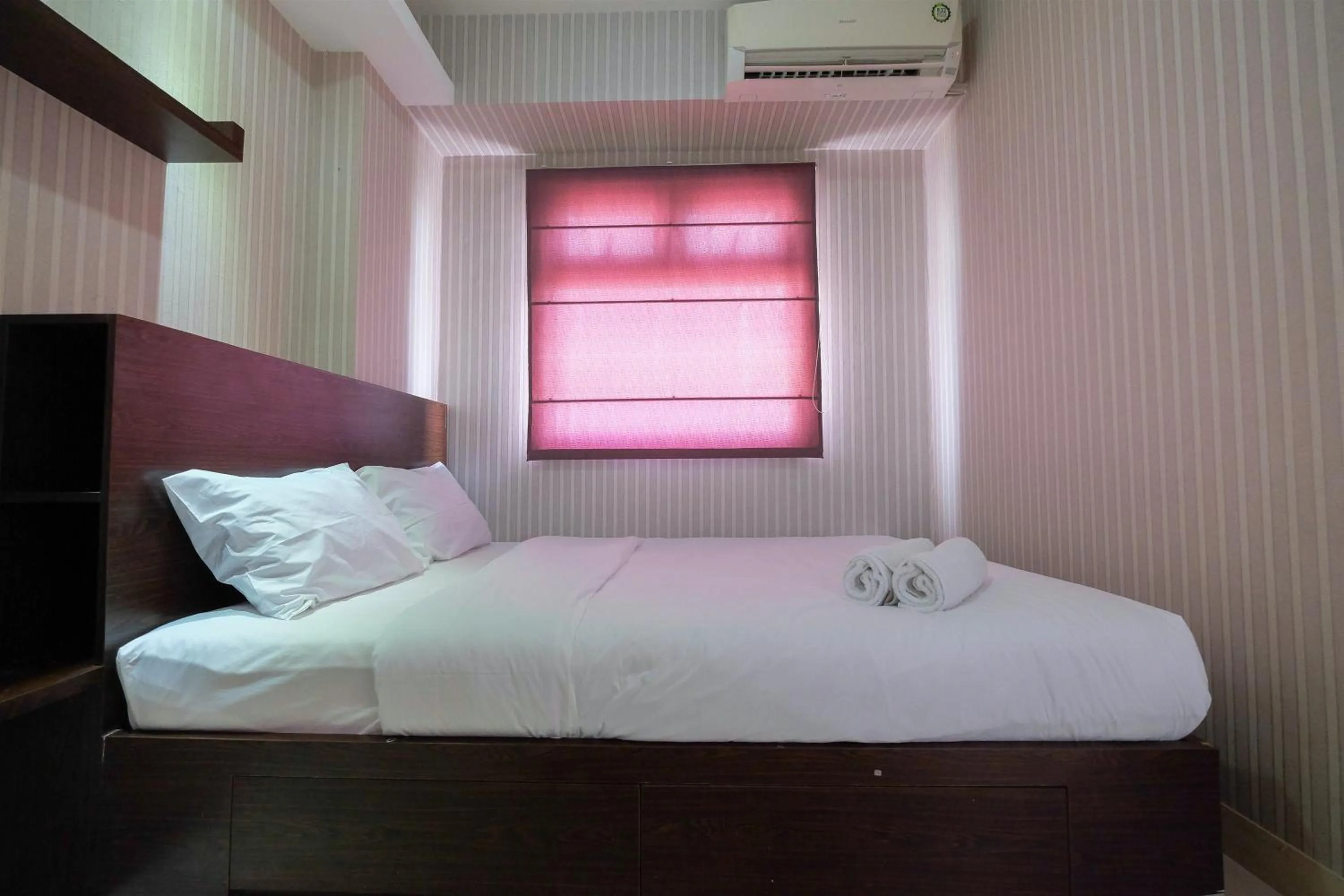Bed in Homey and Relaxing 2BR Green Pramuka City Apartment By Travelio