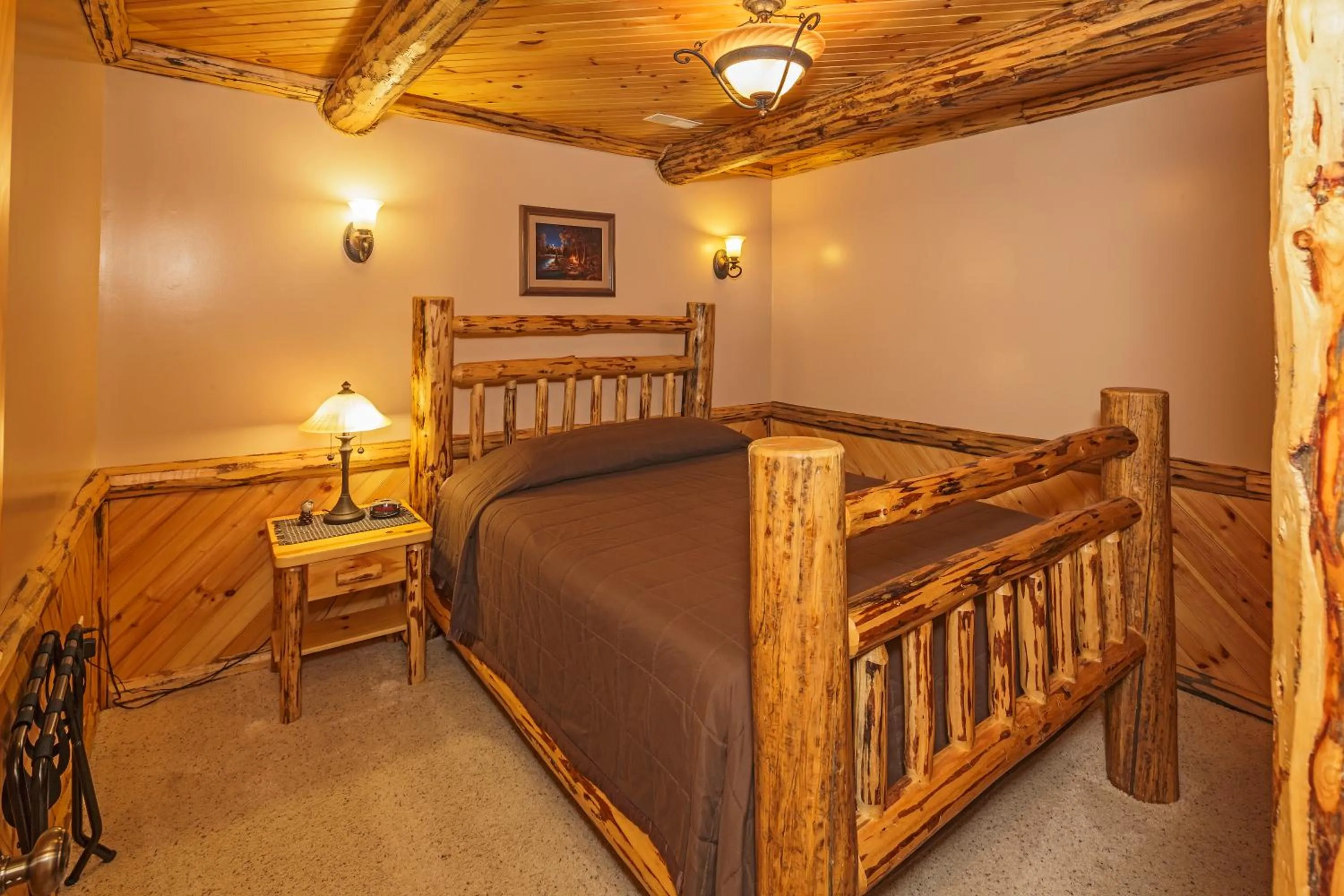 Bed in Sojourner's Lodge & Log Cabin Suites