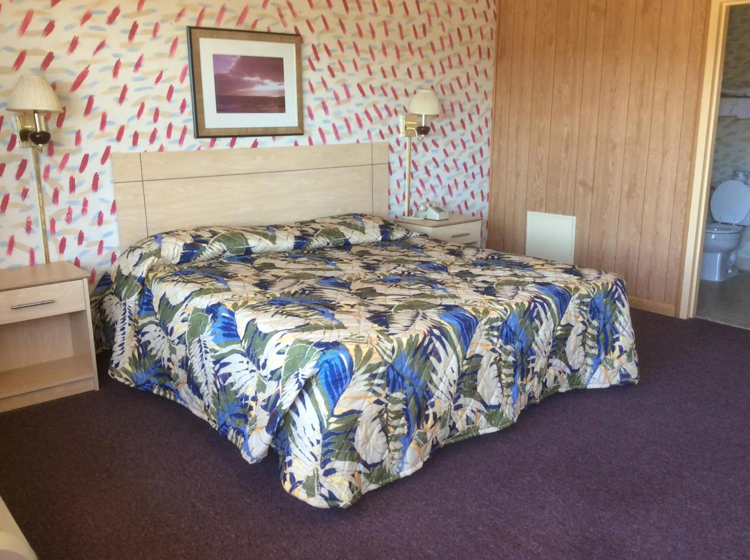 Bed in MacThrift Motor Inn