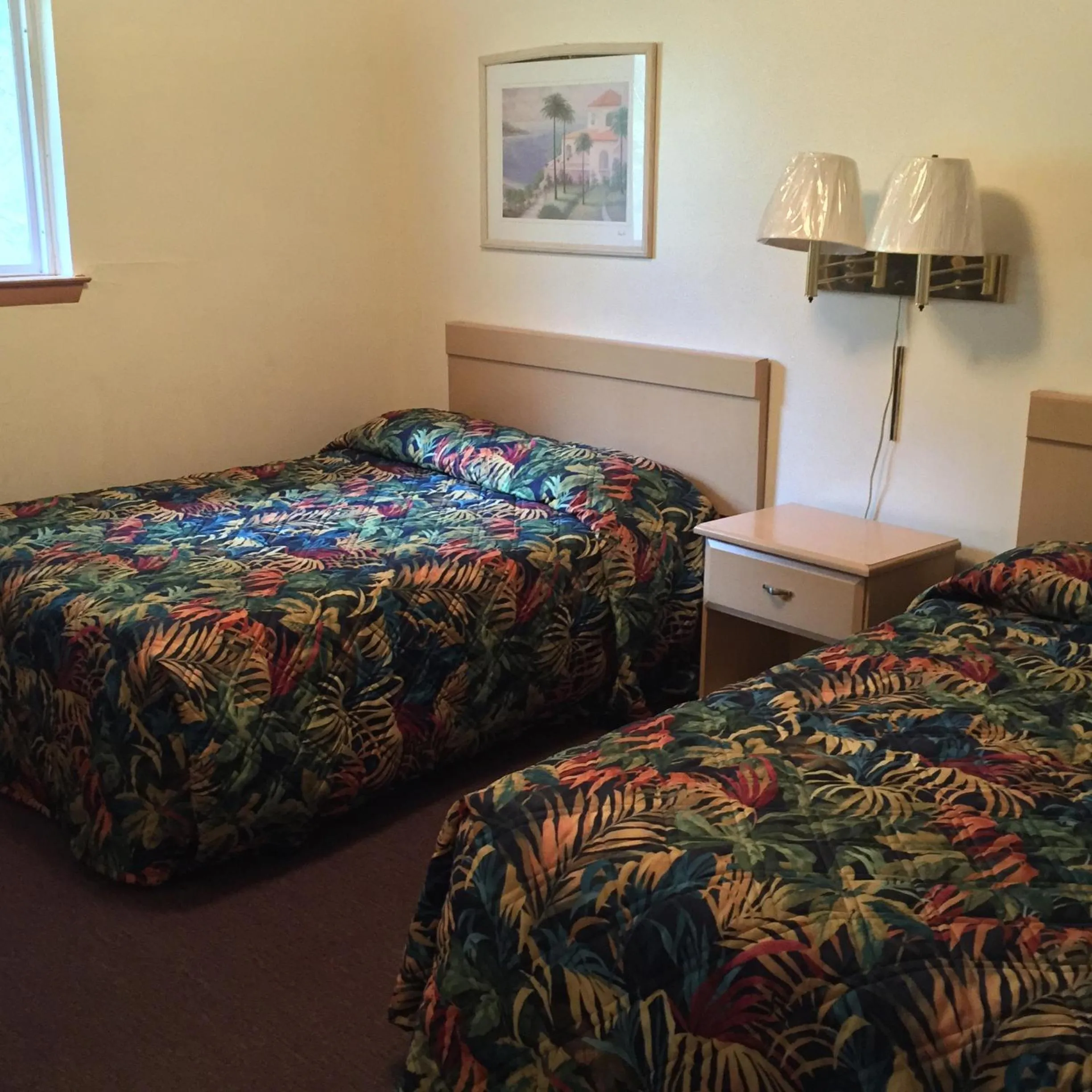 Bed in MacThrift Motor Inn