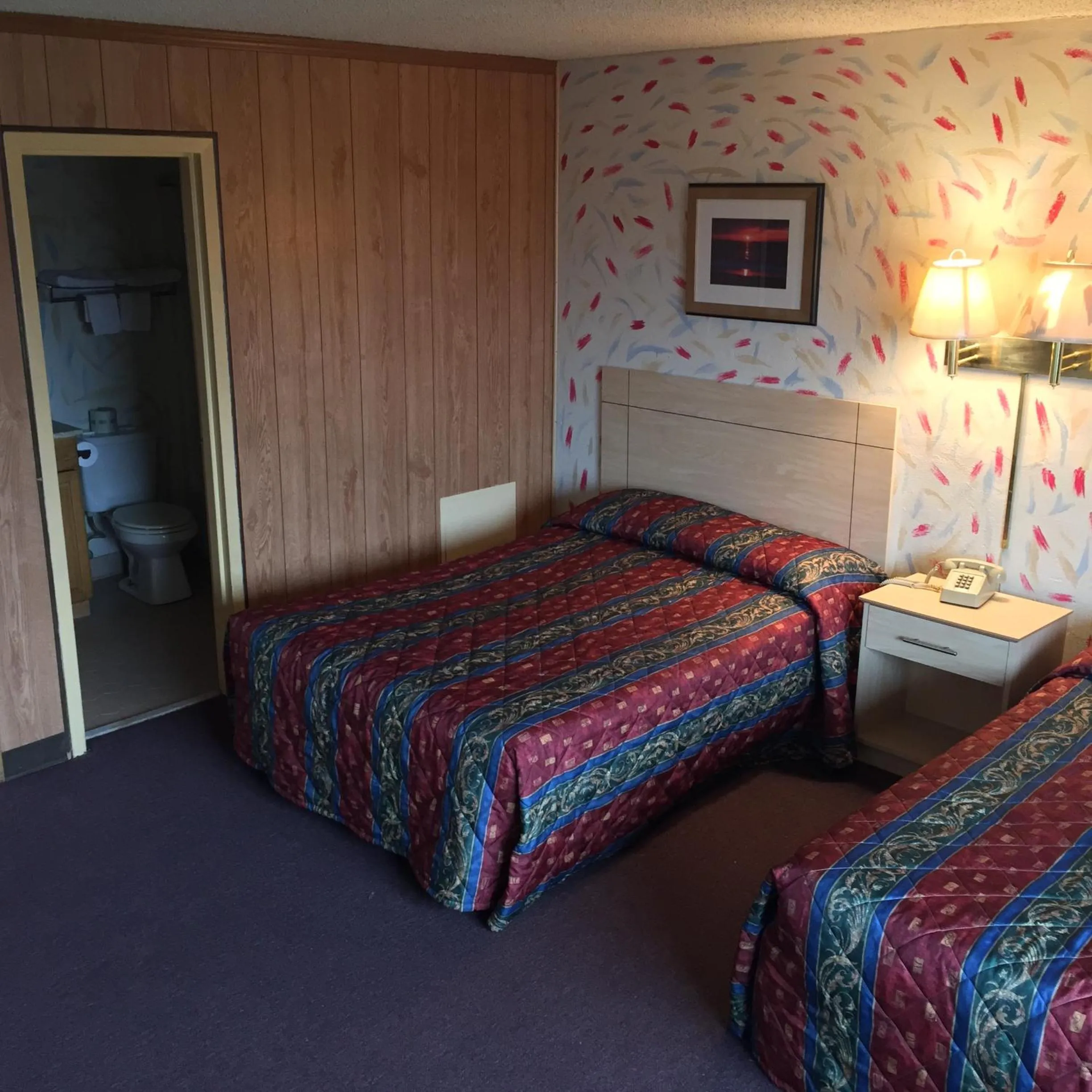 Bed in MacThrift Motor Inn