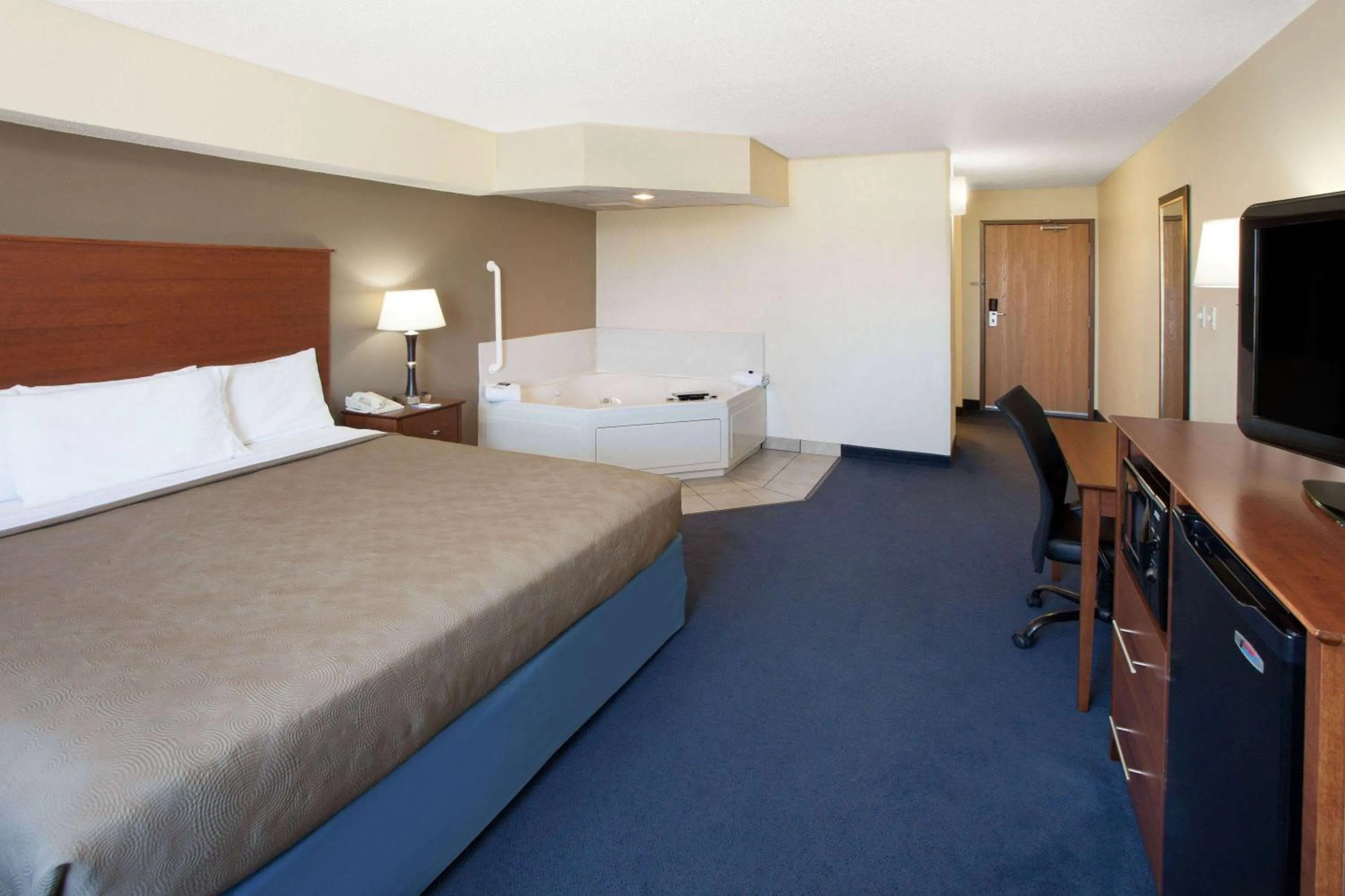 Bed in AmericInn by Wyndham Webster City
