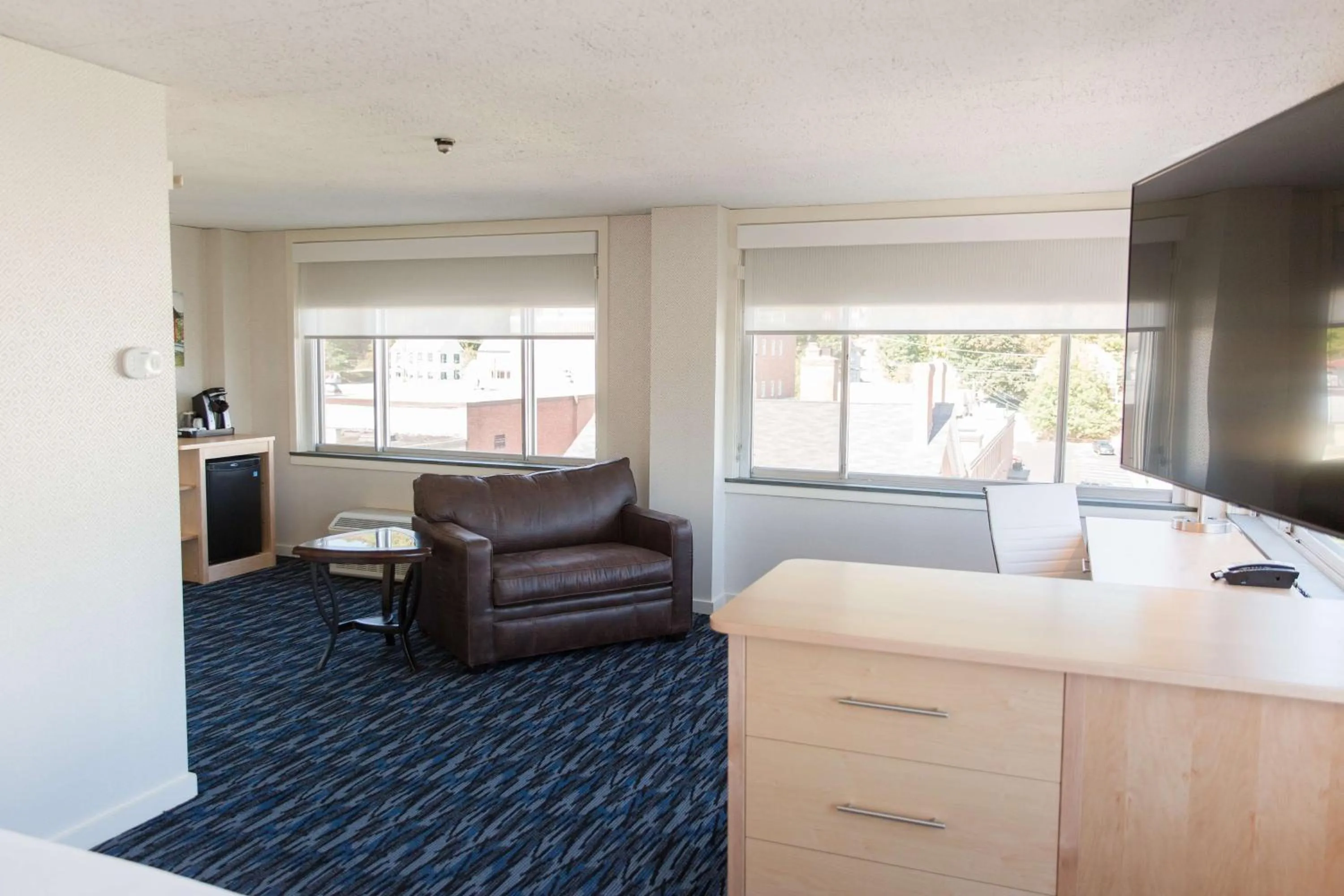 Living room in Capitol Plaza Hotel Montpelier Tapestry Collection by Hilton