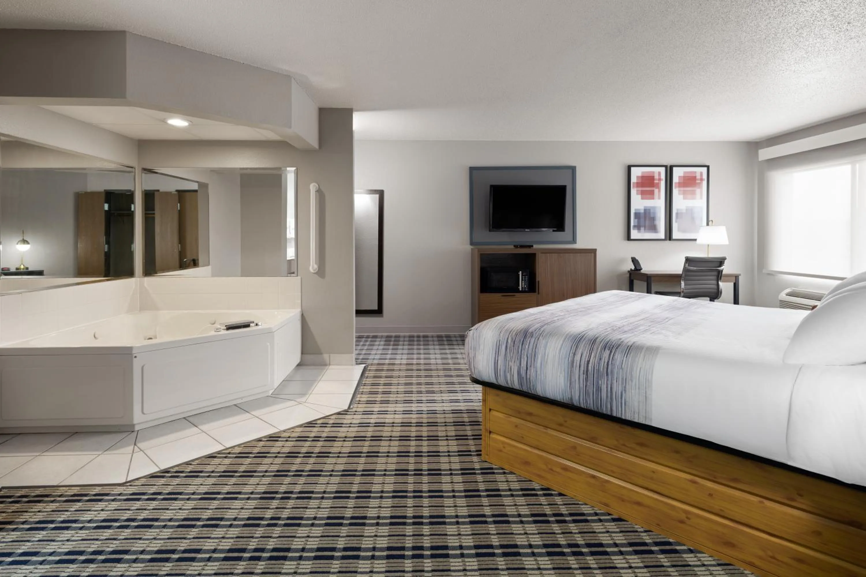 Bed in AmericInn by Wyndham Muscatine